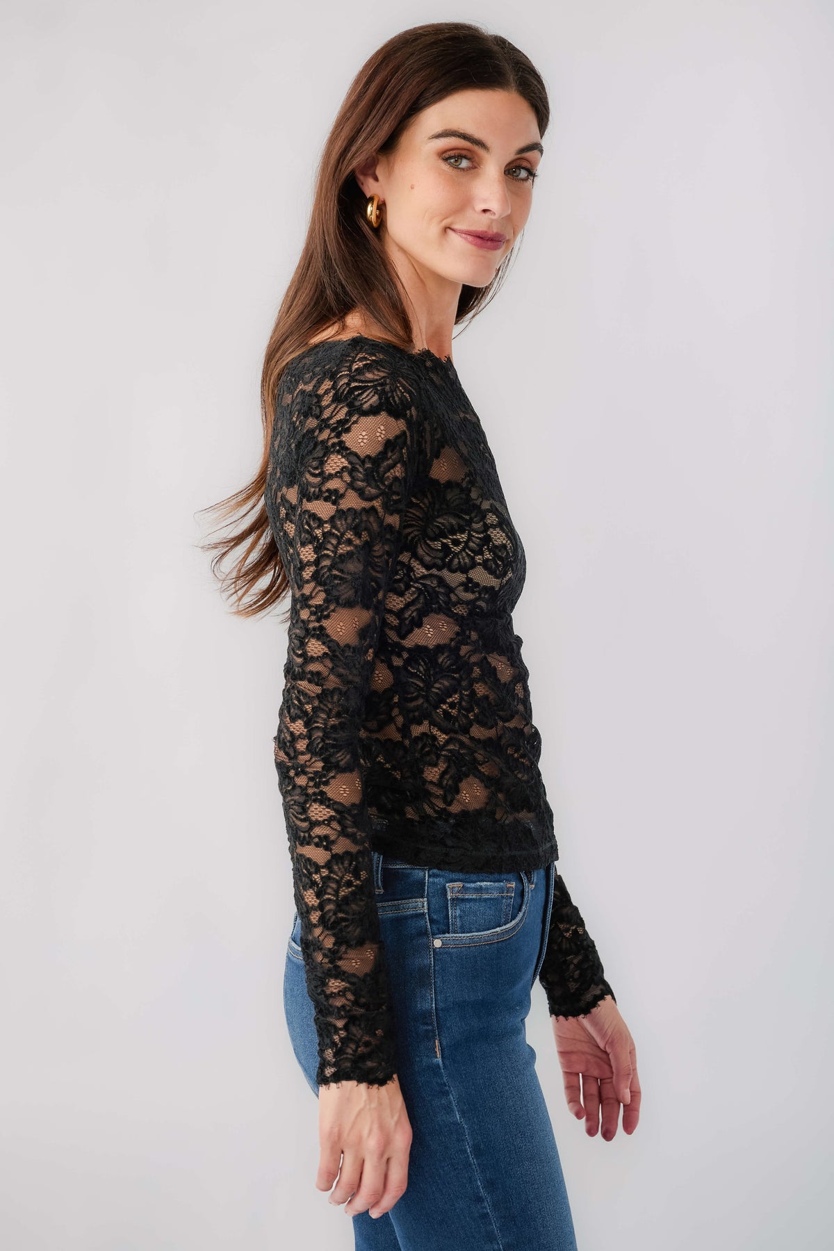Black lace long-sleeve top with crew neckline, sheer lace overlay and fitted waist