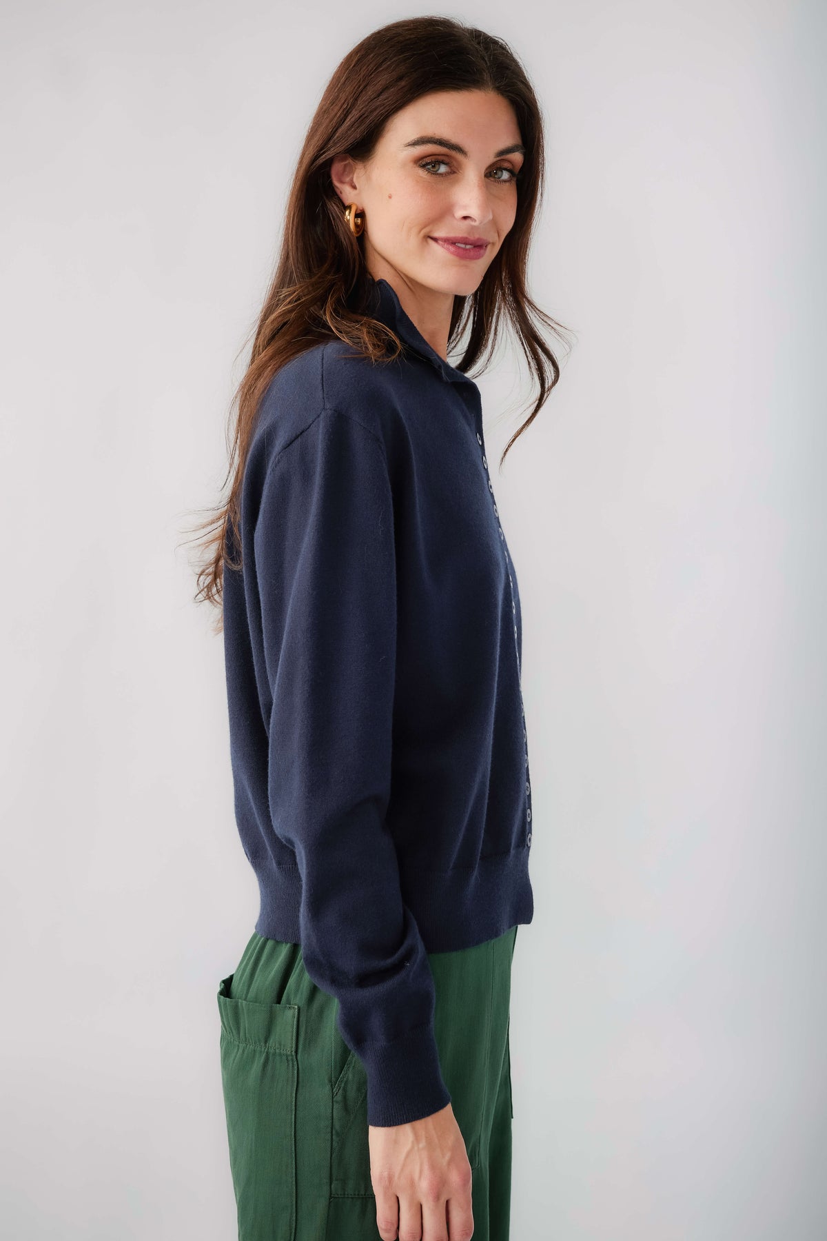 Dark navy mockneck cardigan, side view, button front and long sleeves