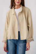 Light beige button-front jacket with stand collar and ribbed striped sleeve cuffs