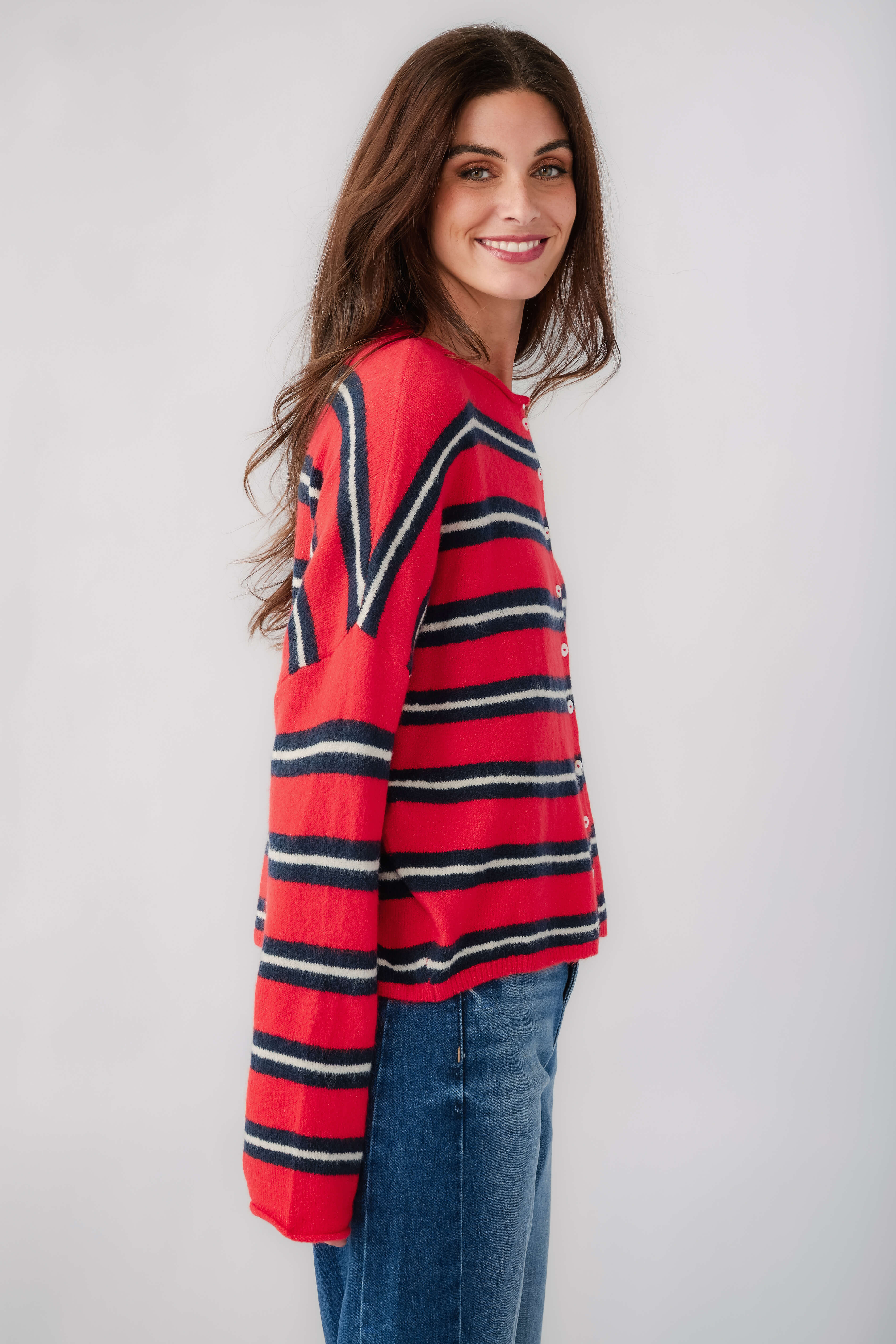 Women’s striped piper cardigan showing side view with red body and dark horizontal stripes