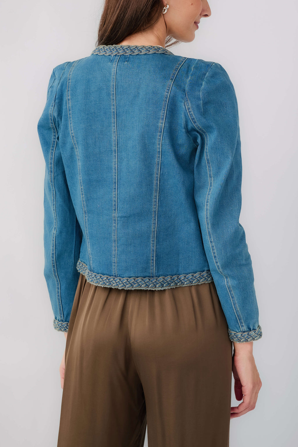 Medium wash denim jacket back view with braided trim hem and cuffs