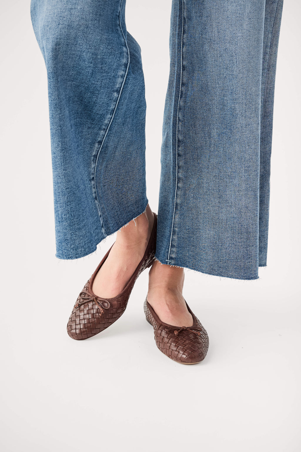 Brown woven ballet flats, close-up of rounded toe and low-profile design