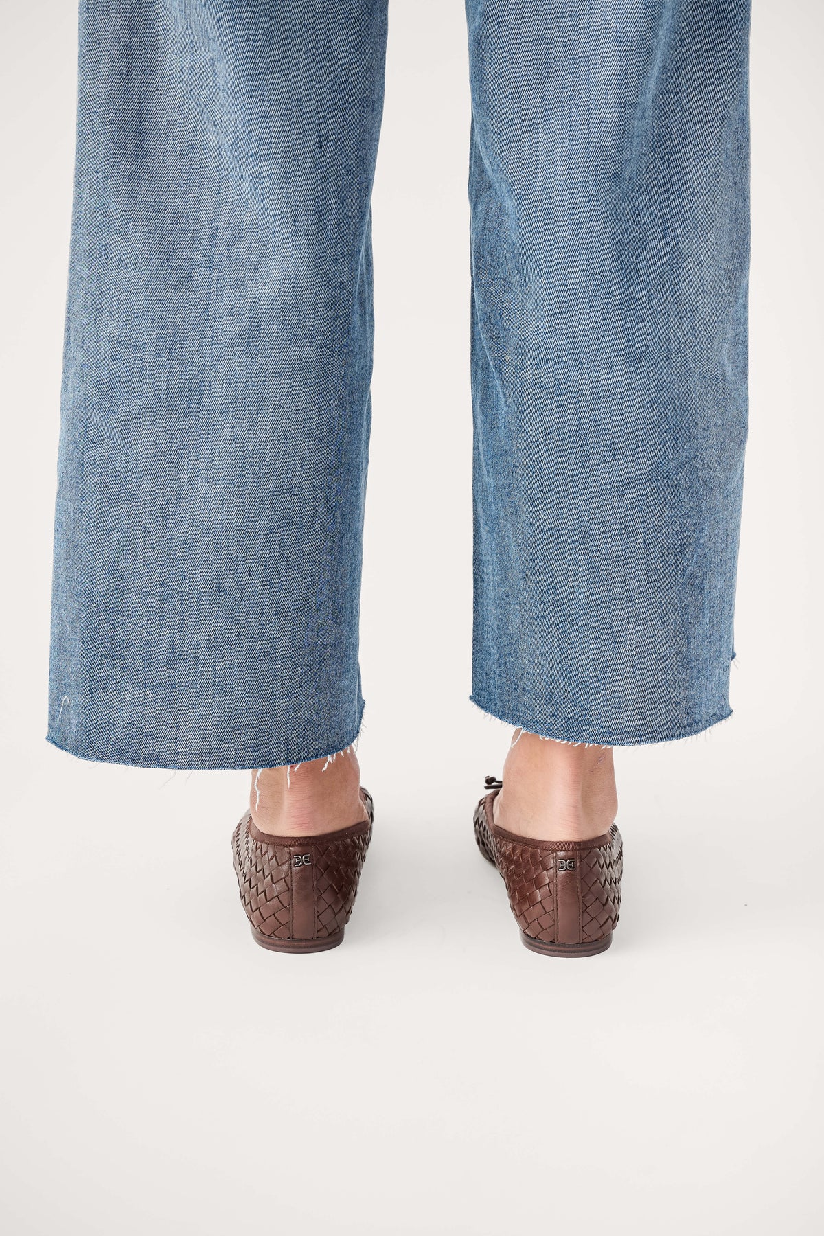 Brown woven ballet flats, rear view with low heel and woven texture