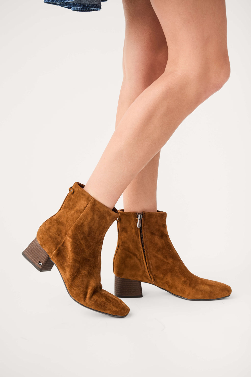 Tan suede ankle boots with stacked heel and side zipper, toe view