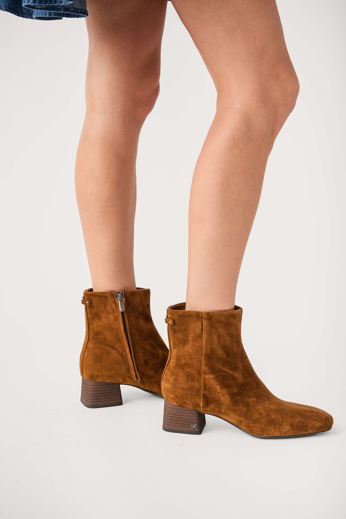 Tan suede ankle boots with side zipper, stacked heel, and rounded toe