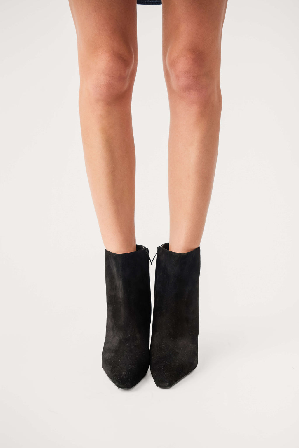 Black suede ankle boots with side pull tabs and low heel