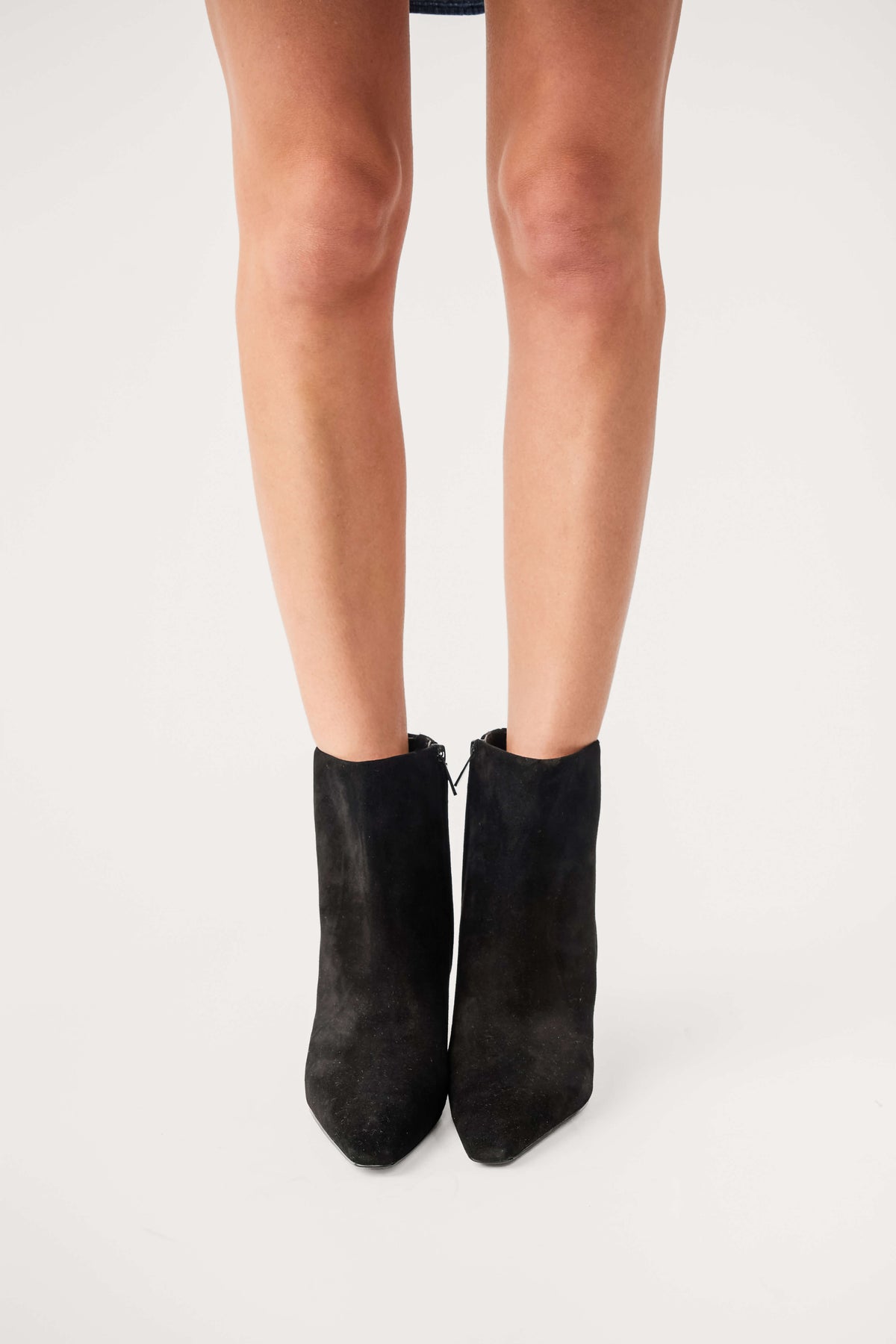 Black suede ankle boots with side pull tabs and low heel