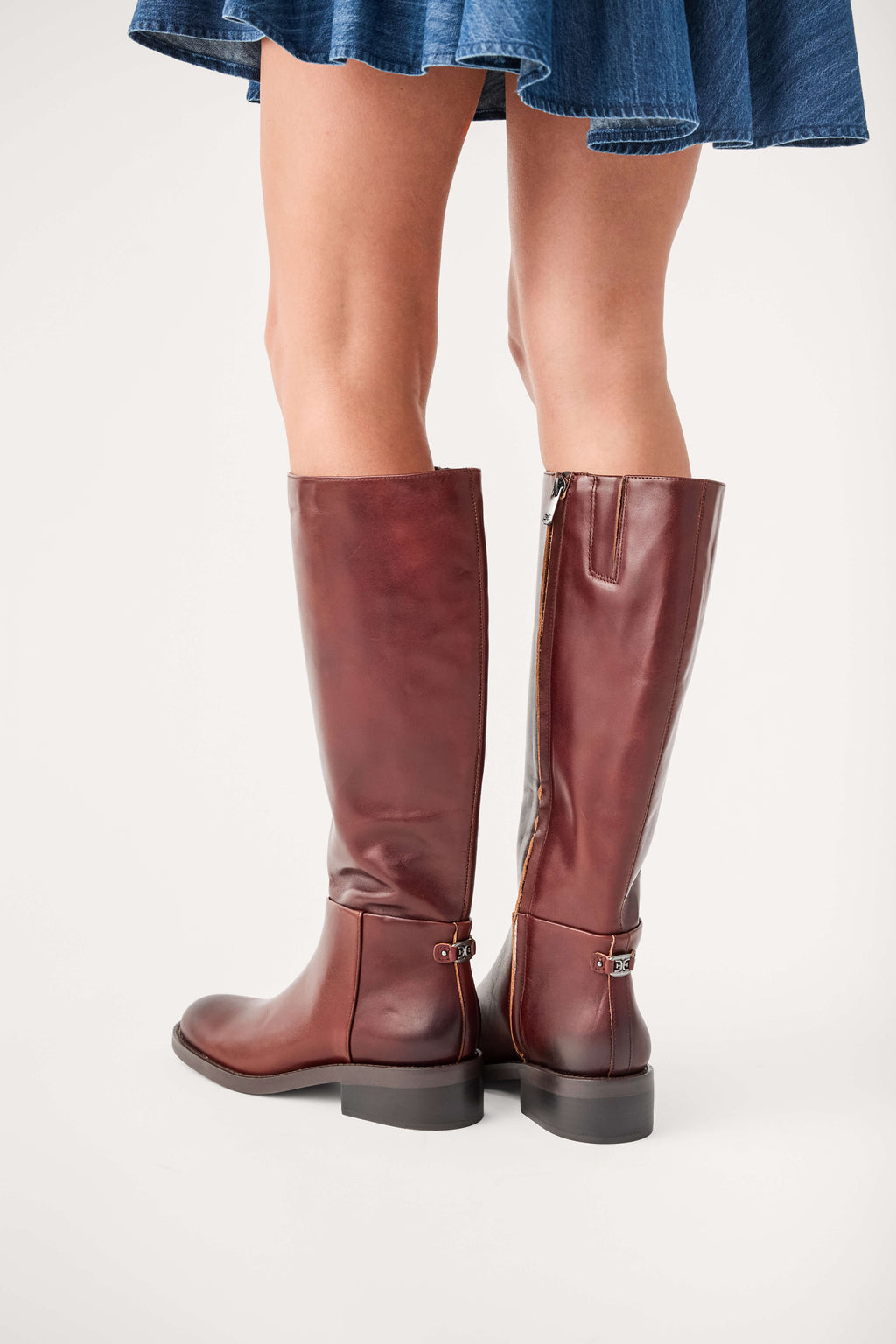 Dark brown leather knee-high boots with side zipper and buckle strap, low stacked heel