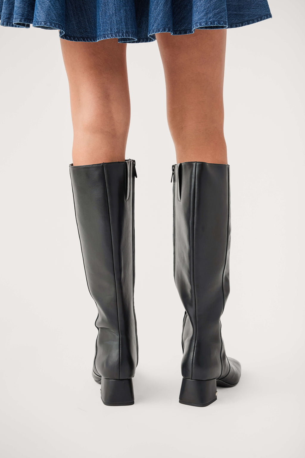 Black knee-high leather boots with block heel and side zipper detail