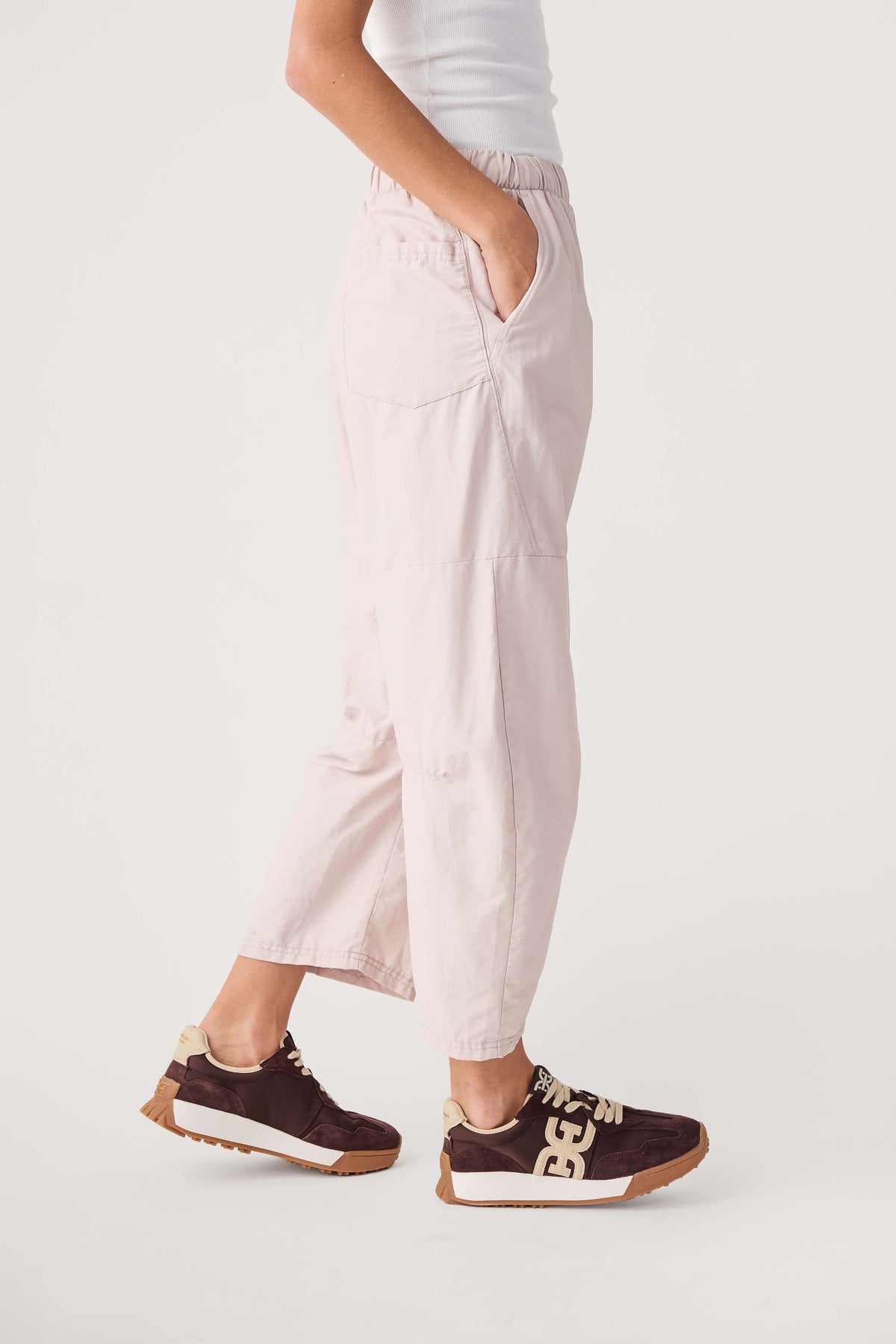 Light pink cropped jogger pants with elastic waistband and side pockets
