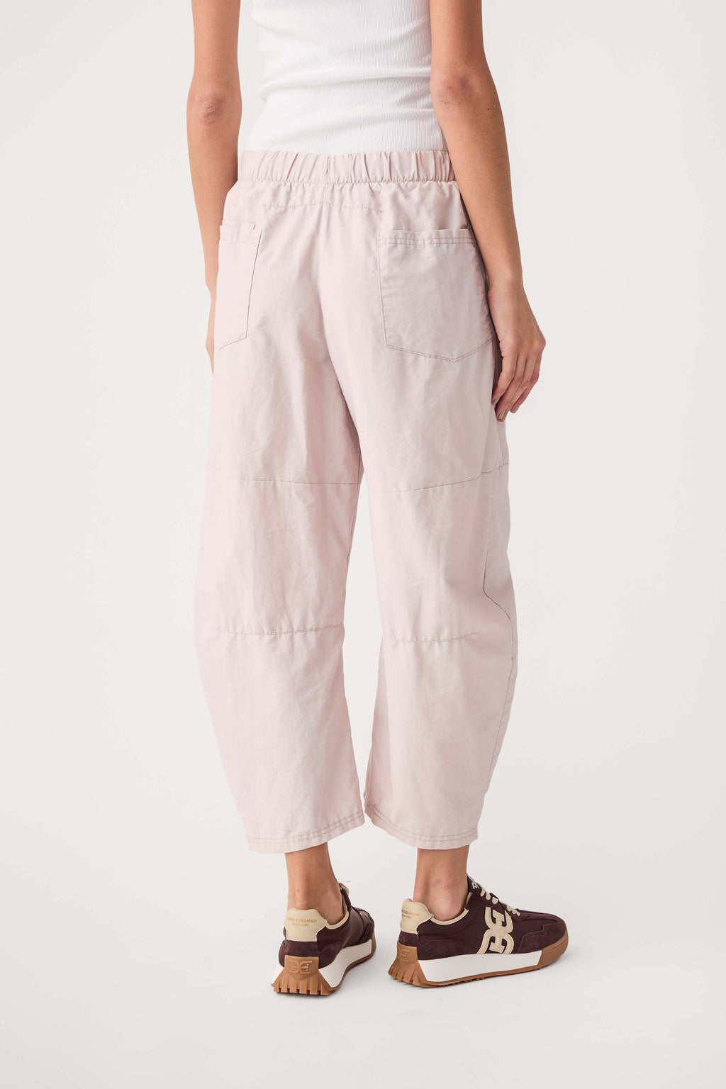 Light pink drawstring jogger pants with elastic waistband and side pockets