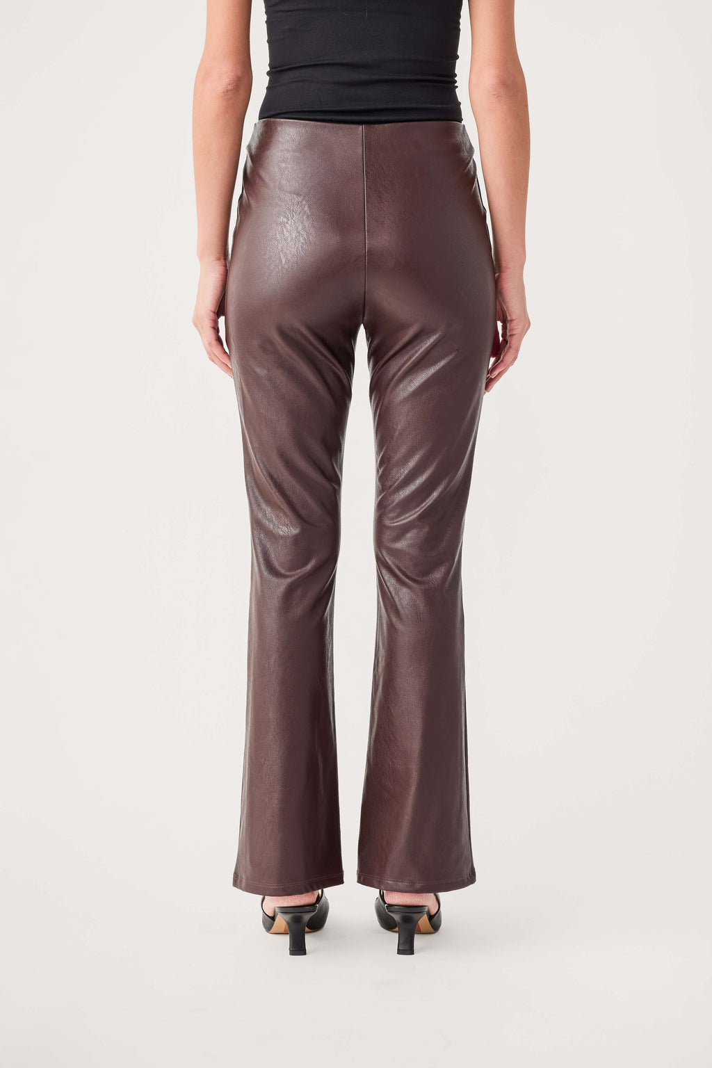 Dark taupe-brown faux leather flare pants, back view with center seam