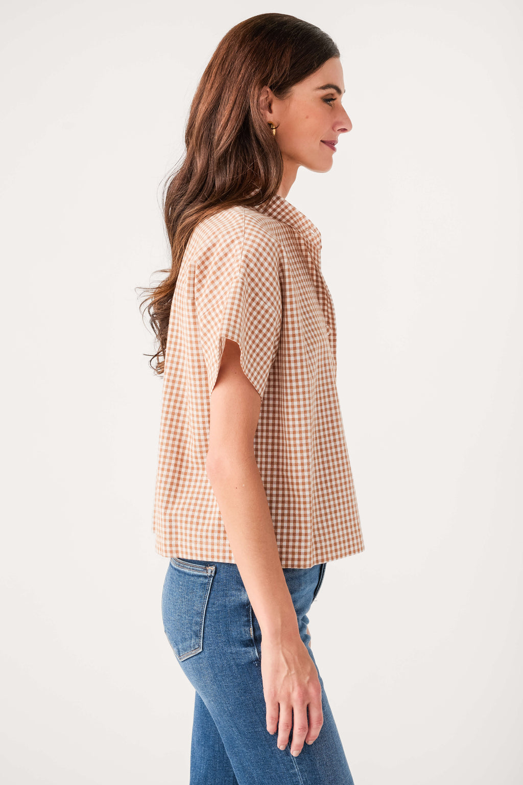 Tan-and-white gingham short-sleeve button-up top, side view