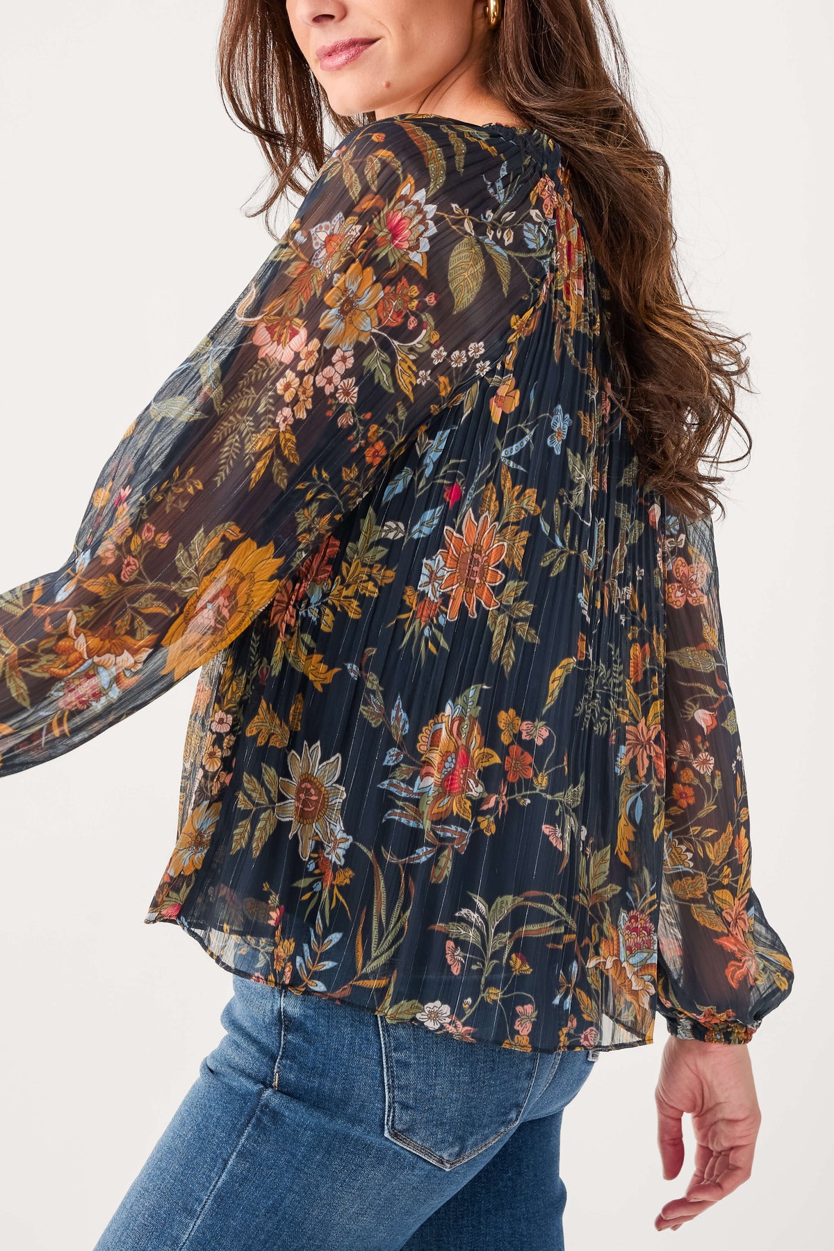 Navy floral pleated blouse with gathered neckline and flowing long sleeves