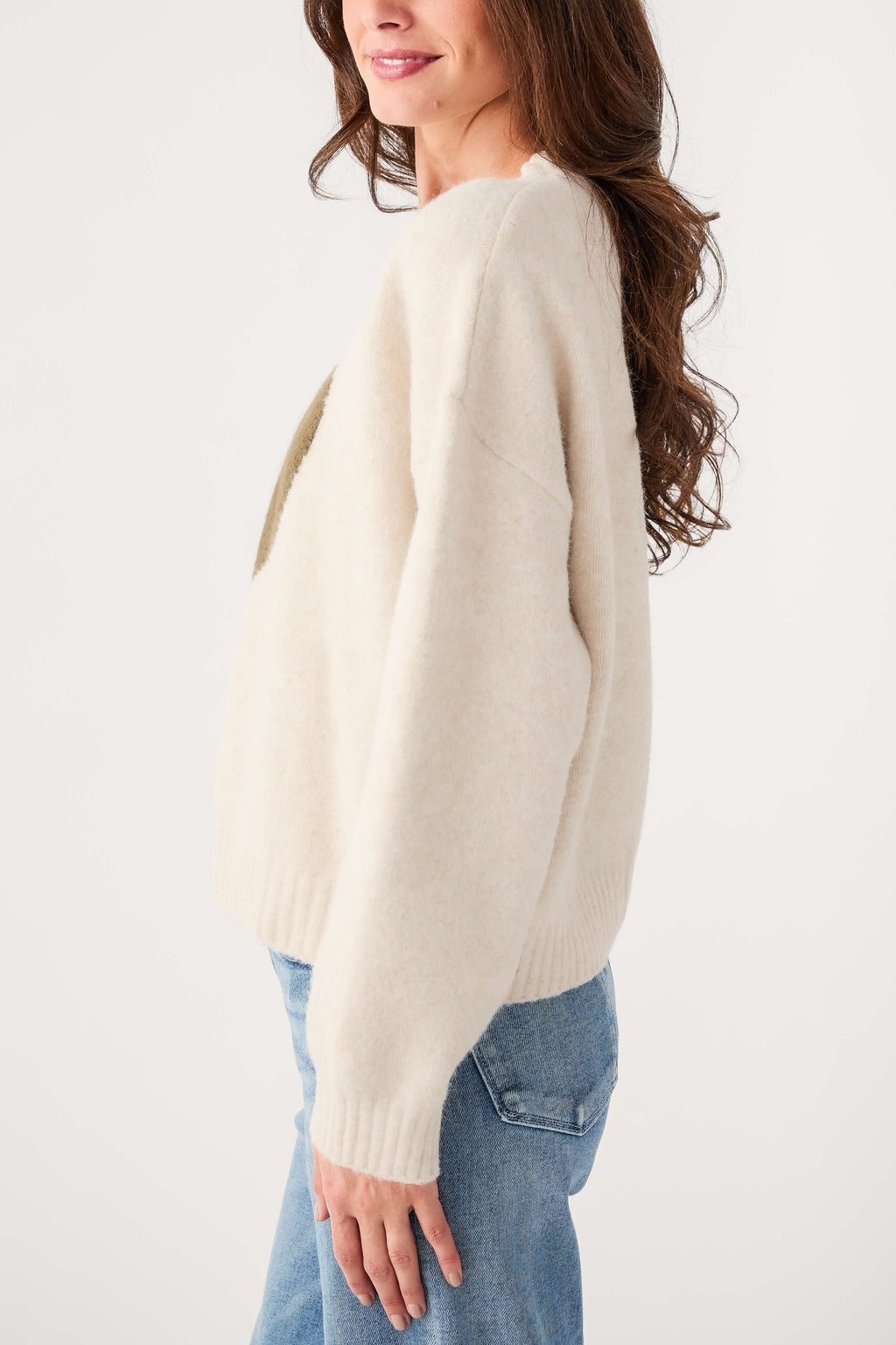 Cream knit sweater, side view with ribbed knit cuffs and hem