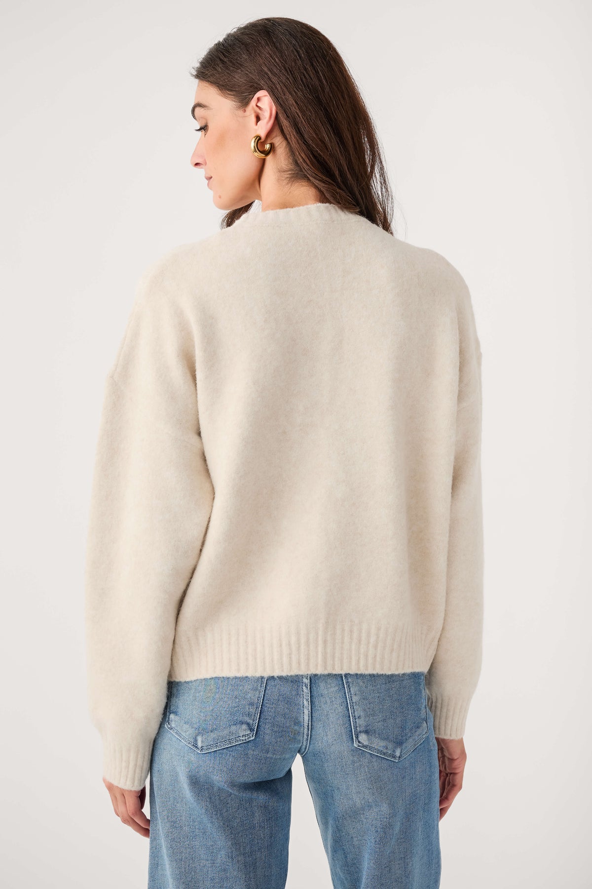 Cream knit sweater, back view with ribbed waistband and long sleeves