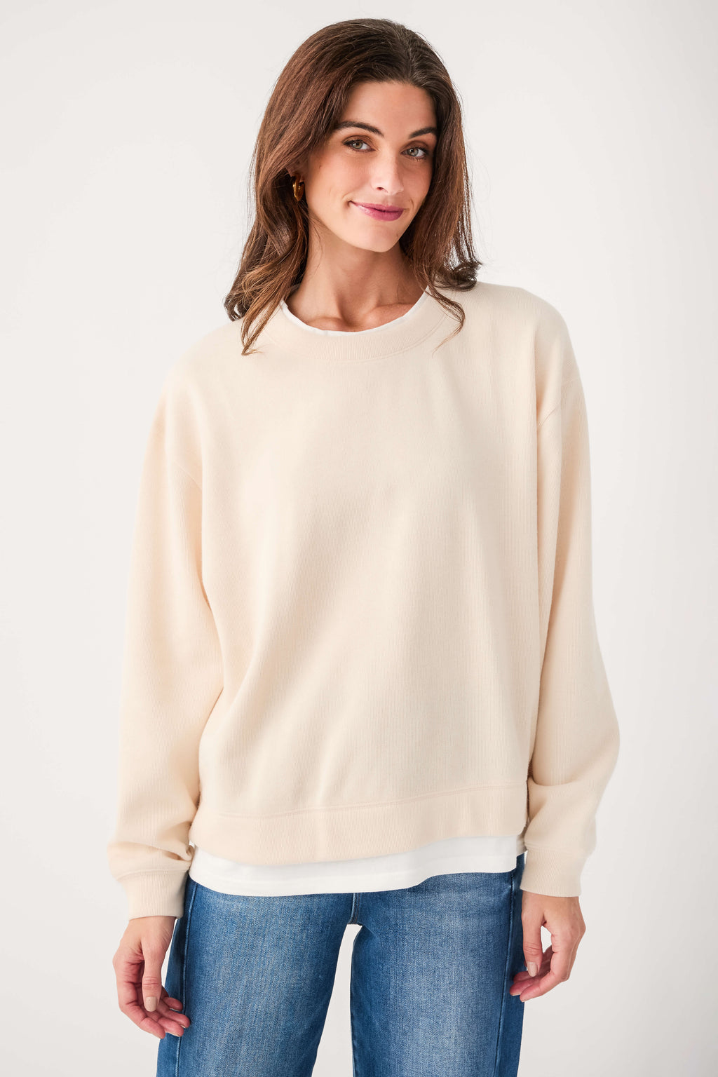 Cream crewneck pullover sweater with long sleeves and ribbed hem and cuffs