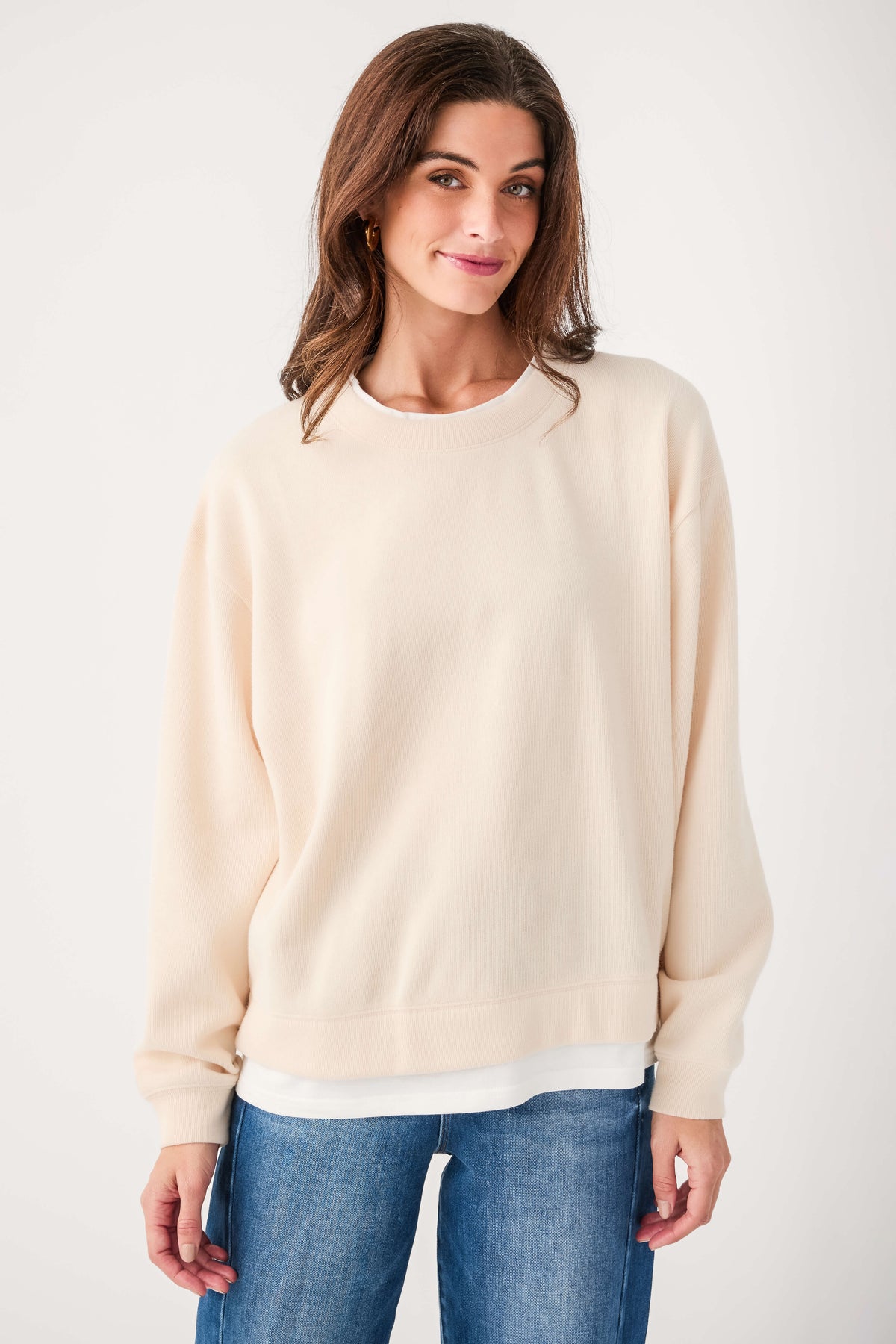 Cream crewneck pullover sweater with long sleeves and ribbed hem and cuffs