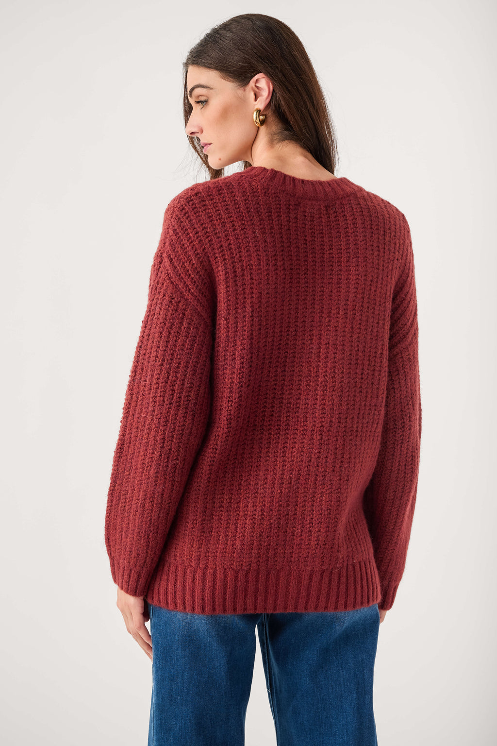 Red knit cardigan back view with ribbed cuffs and straight hem