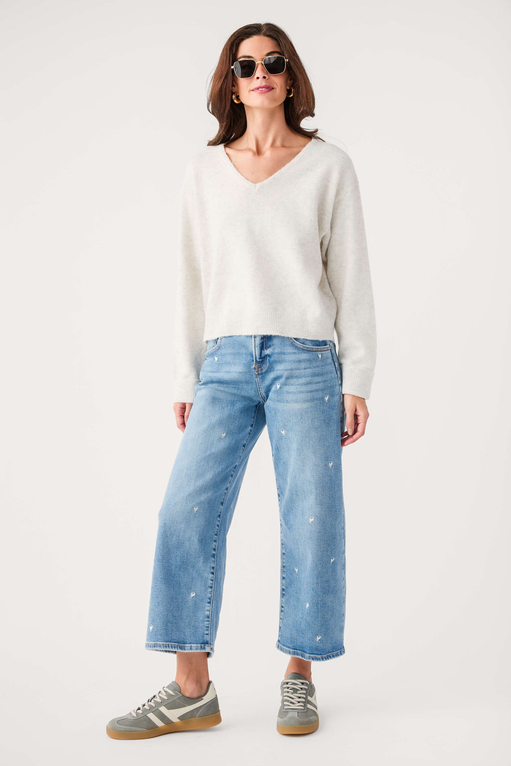 Light gray V-neck knit sweater with long sleeves and relaxed fit