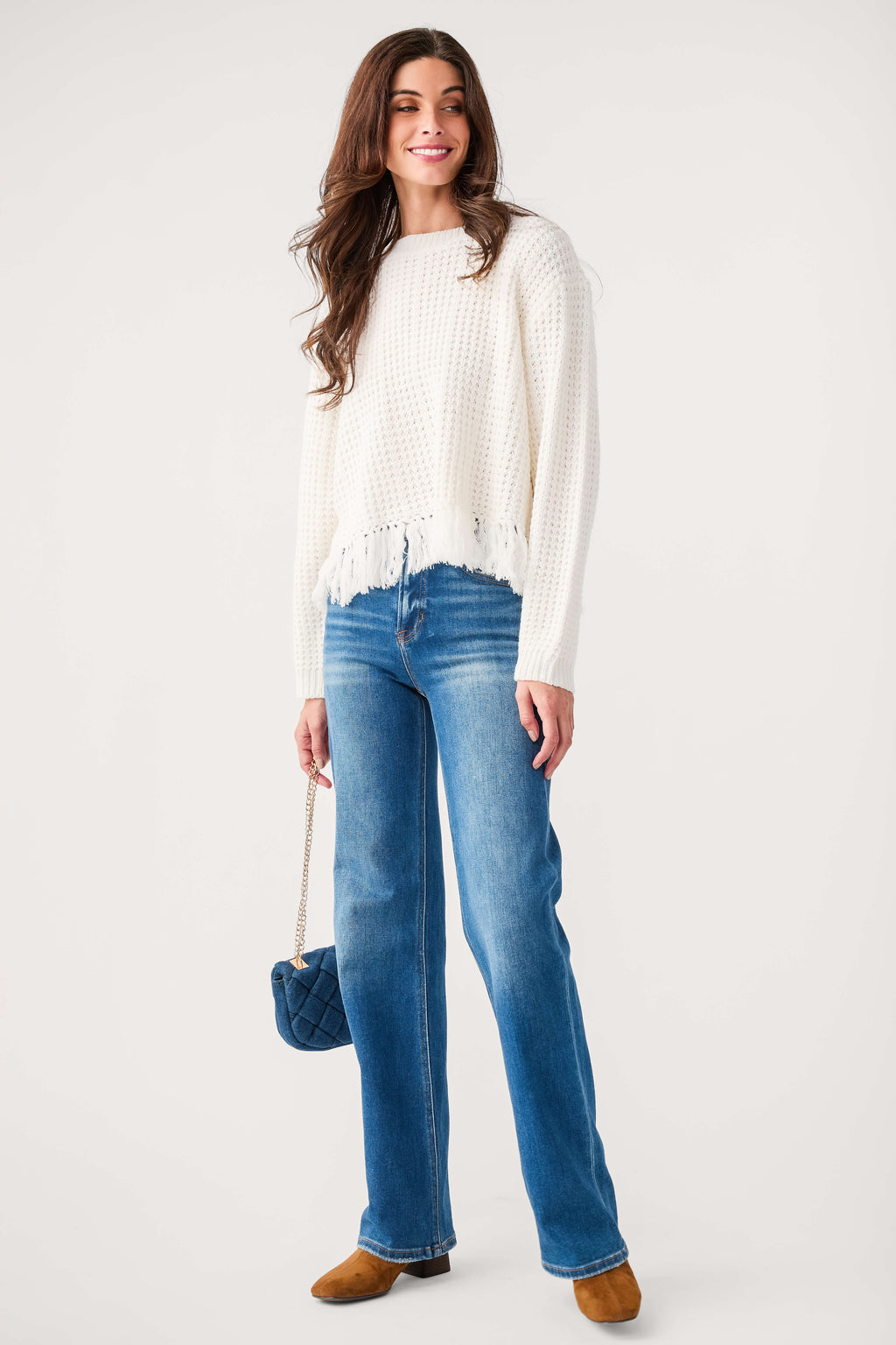White textured knit crewneck sweater with fringe hem, long sleeves