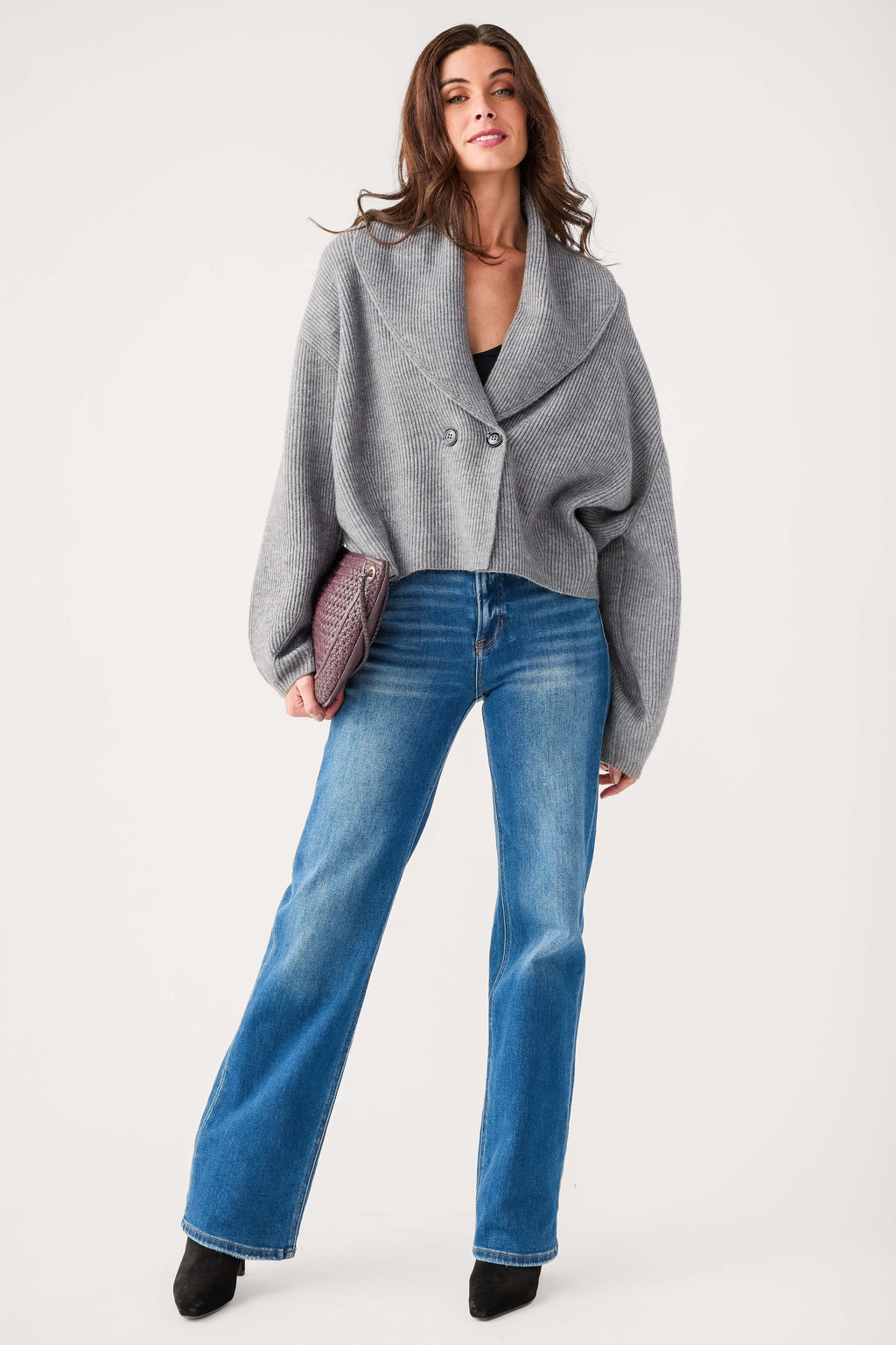 Blue high-rise straight-leg jeans with medium wash worn with gray blazer and black boots.