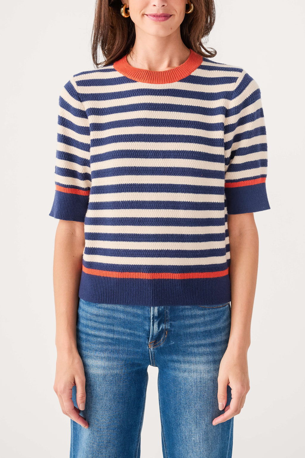 Striped knit top with crew neckline, navy and cream stripes, orange-red ribbed hem