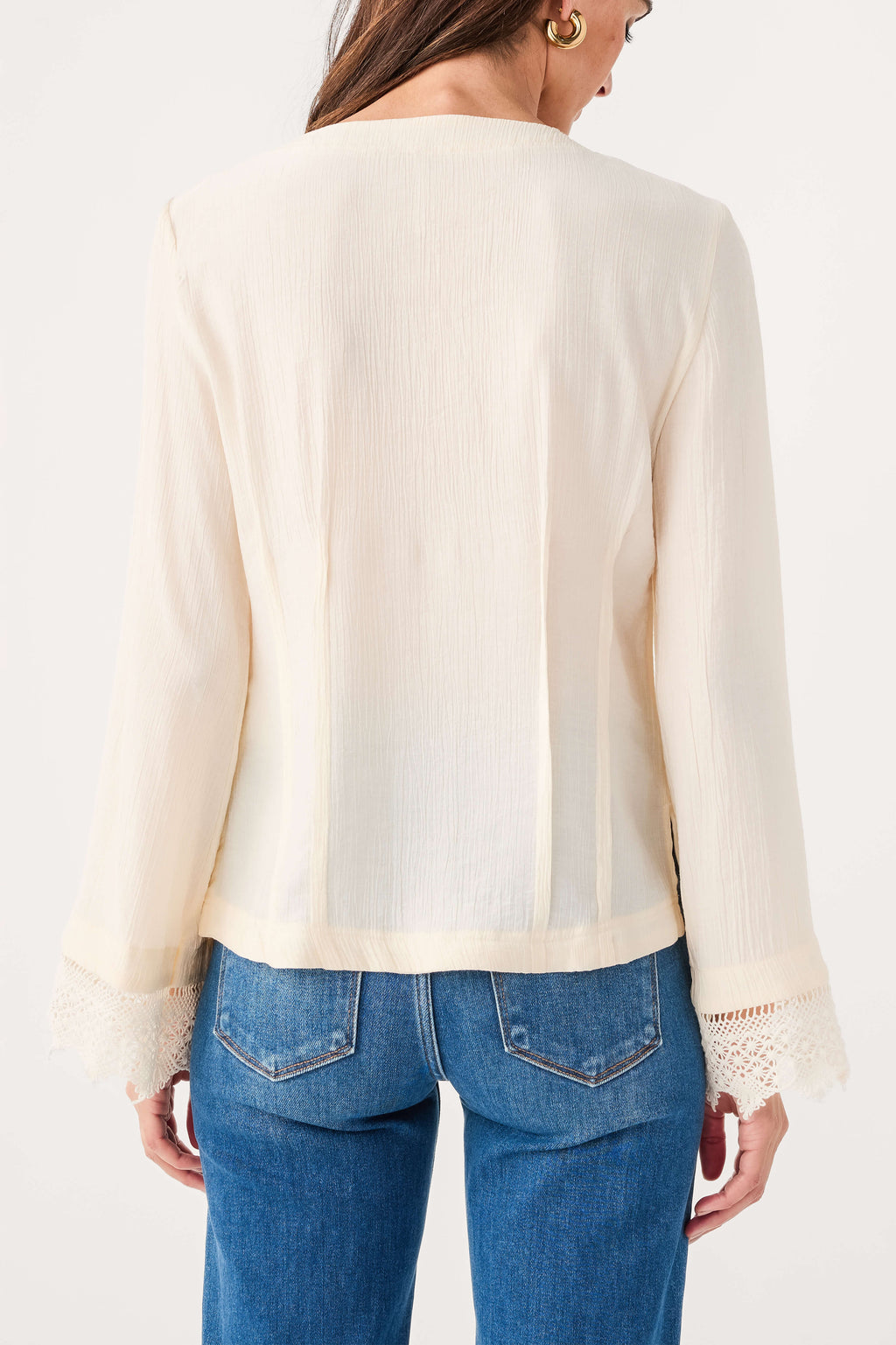 Ivory blouse back view with long sleeves and lace-trim cuffs