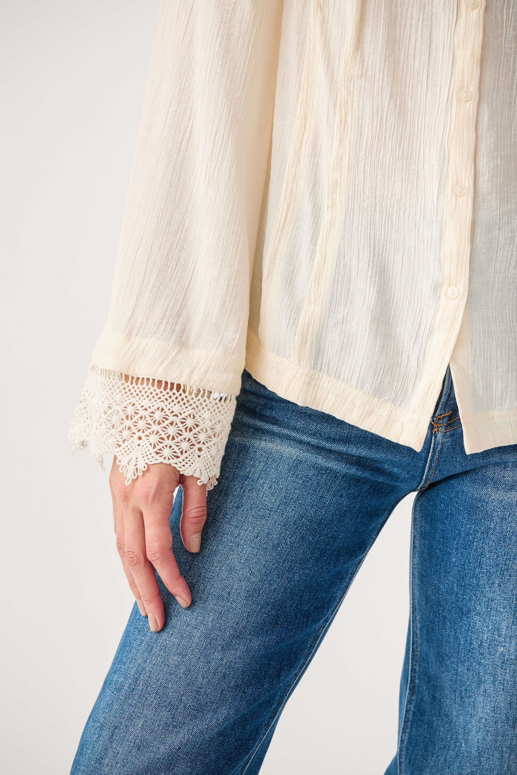Ivory blouse sleeve with crochet lace cuff detail