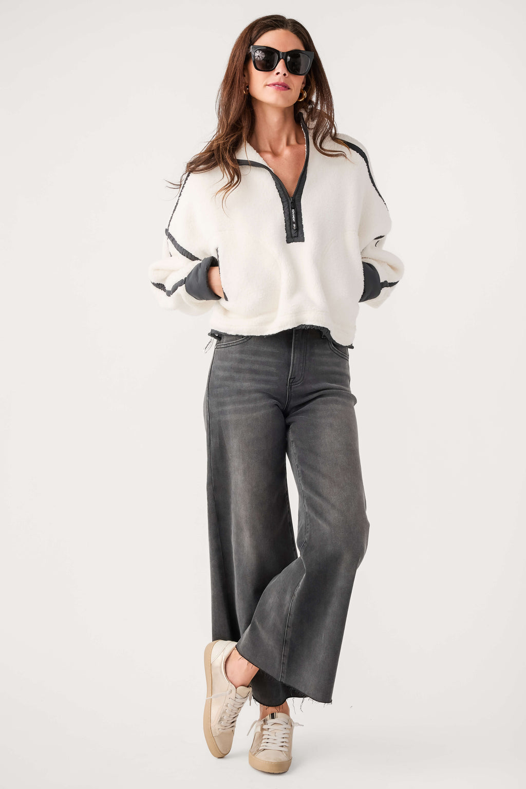 White fleece 1/2-zip pullover with black zip and dark contrast cuffs, relaxed fit