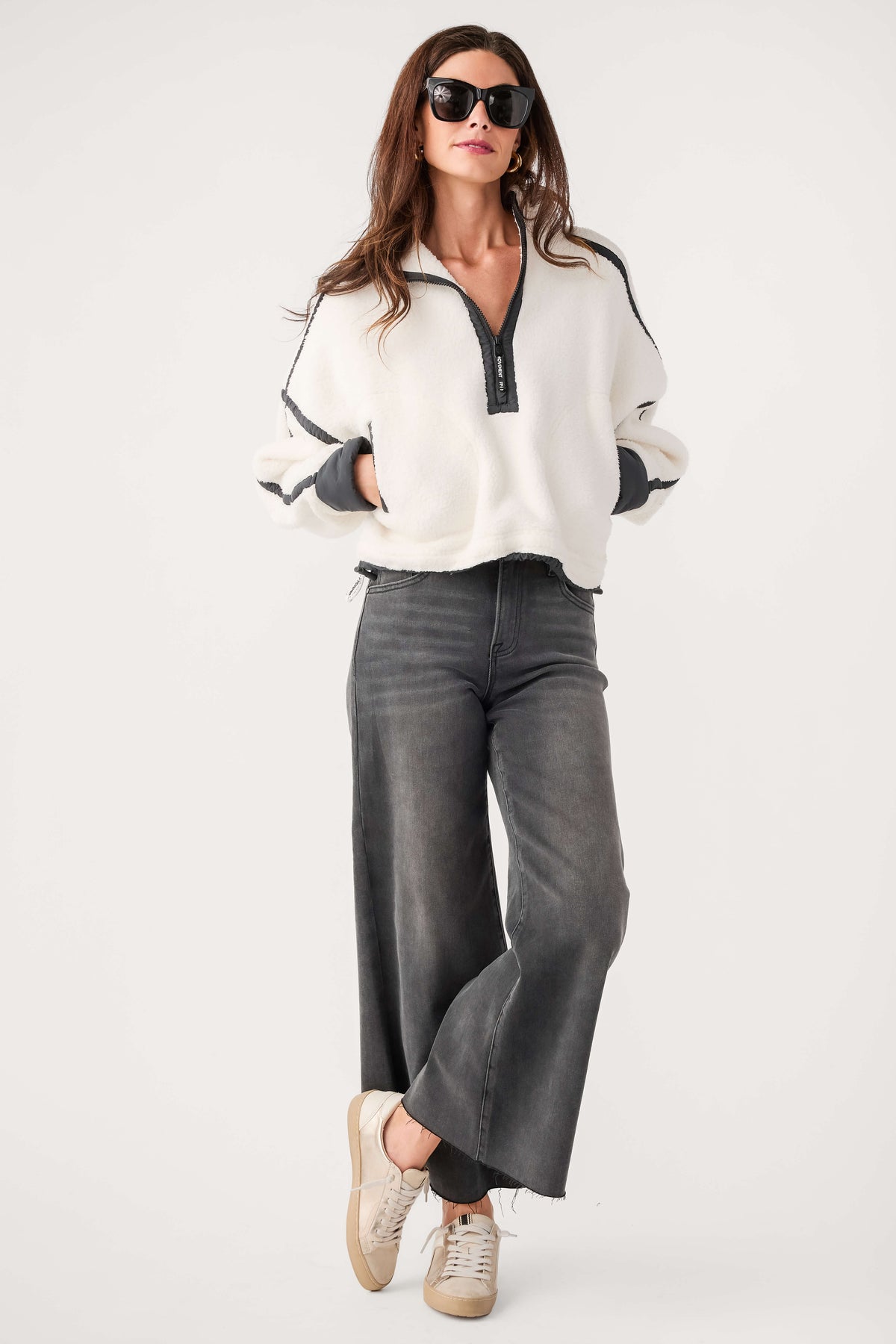White fleece 1/2-zip pullover with black zip and dark contrast cuffs, relaxed fit