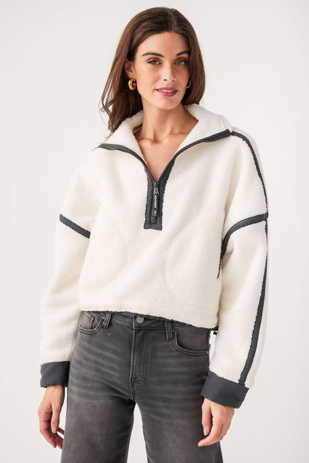 White fleece 1/2-zip pullover with black zipper, stand collar, and contrast cuffs