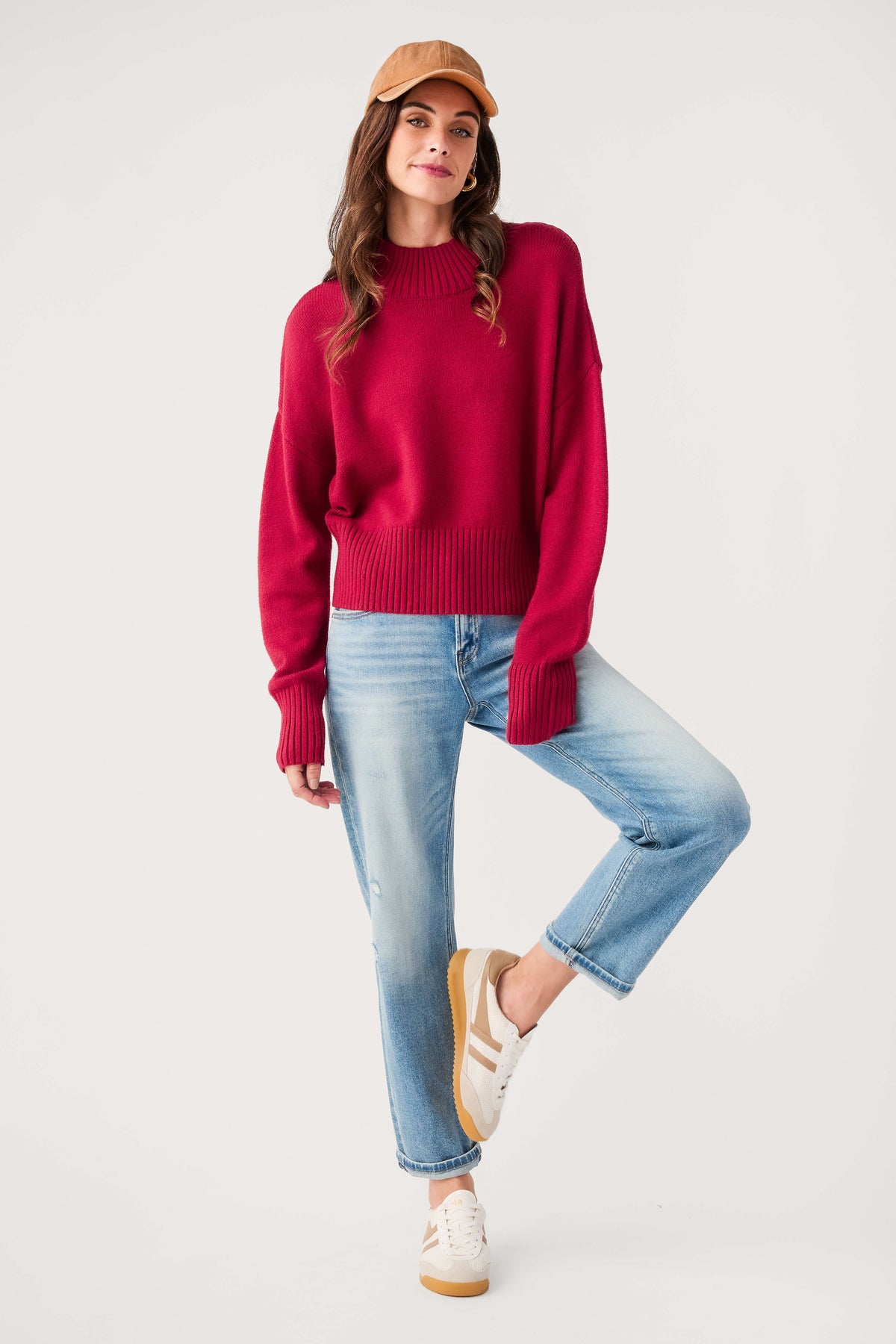 Wine mock neck sweater with ribbed cuffs and hem, paired with blue jeans