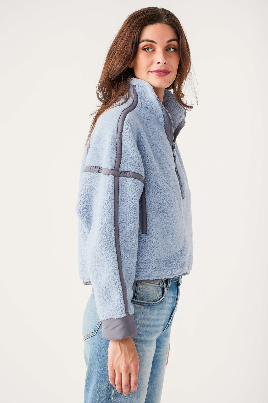 Light blue fleece 1/2-zip pullover with gray trim, funnel collar, and thumb cuffs