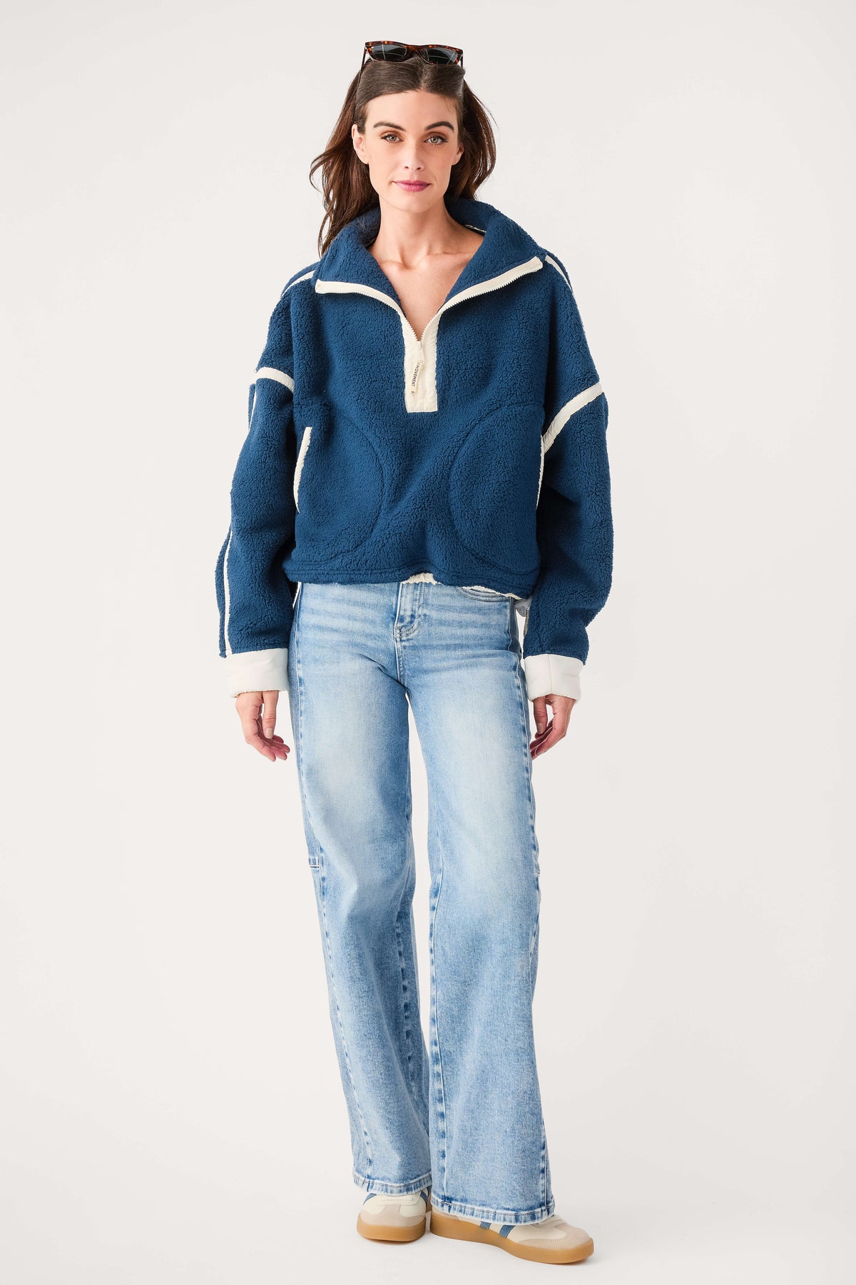 Navy blue half-zip fleece pullover with white trim and quarter-zip collar