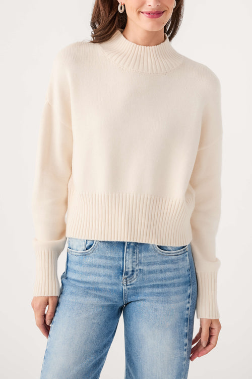 Ivory mock neck sweater with ribbed neckline and cuffs, knit texture detail