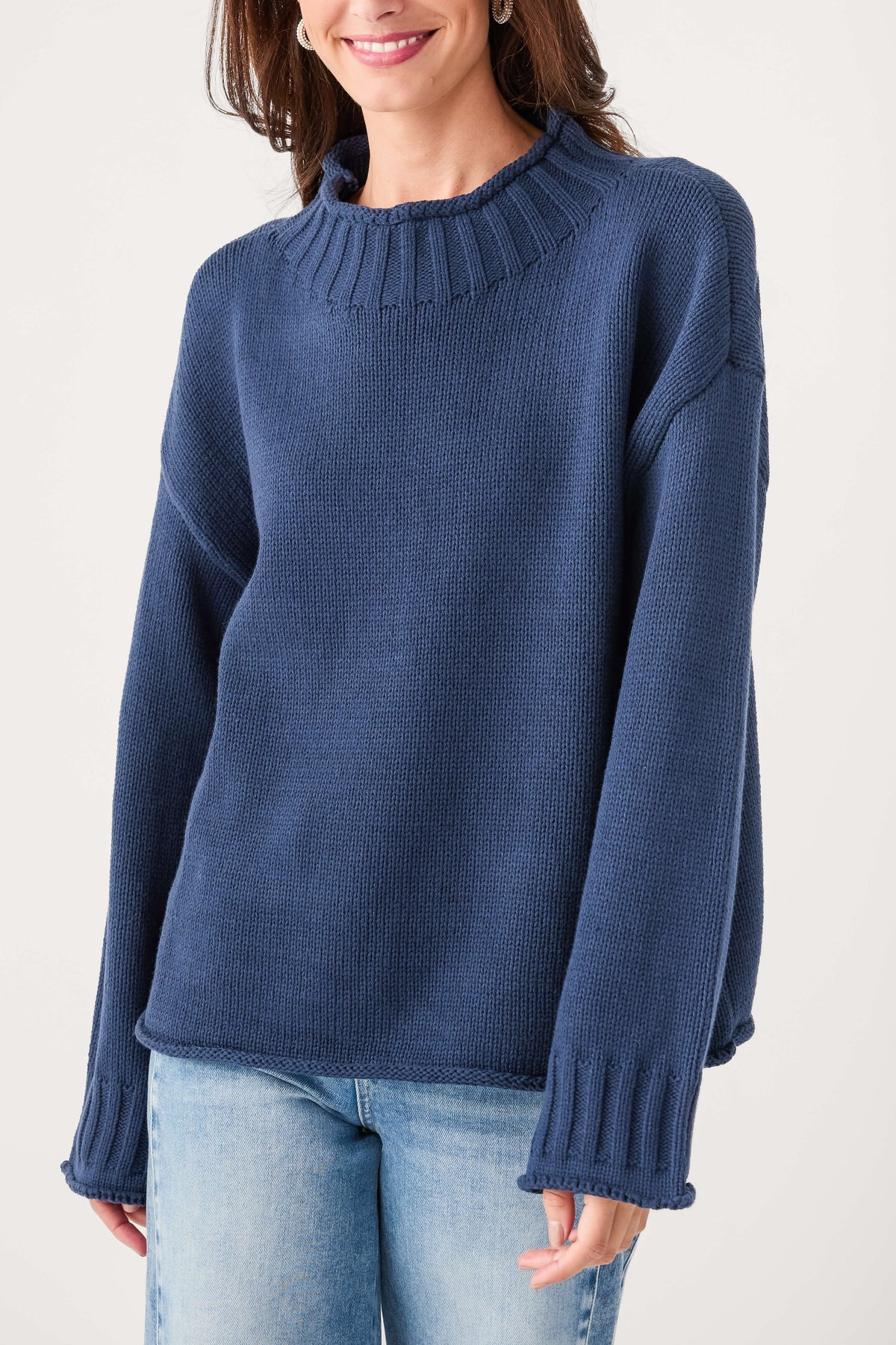 Navy mock neck knit sweater with ribbed neckline and long sleeves