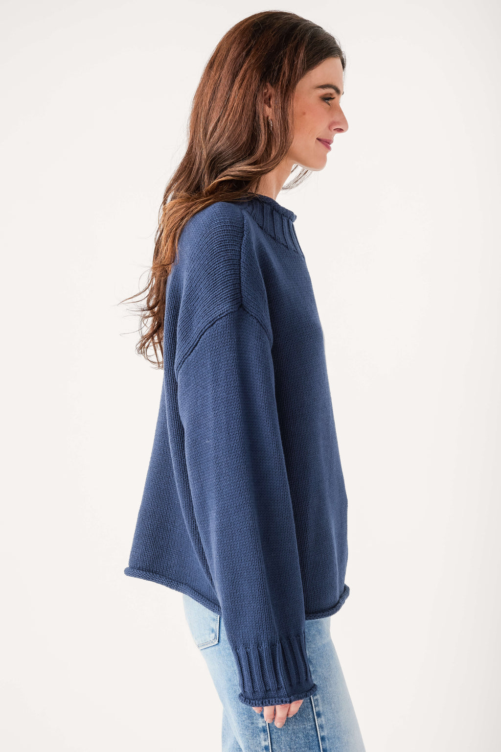 Navy mock neck knit sweater side view with ribbed cuffs and hem