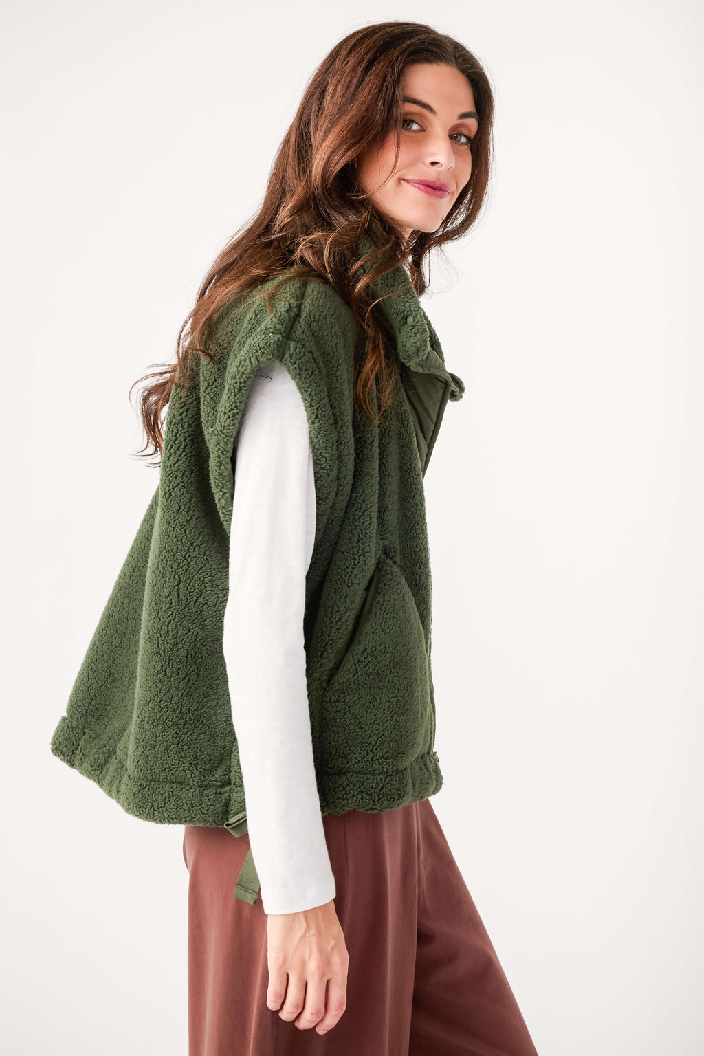 Dark green fleece vest with stand collar, button front, and relaxed fit, side view.