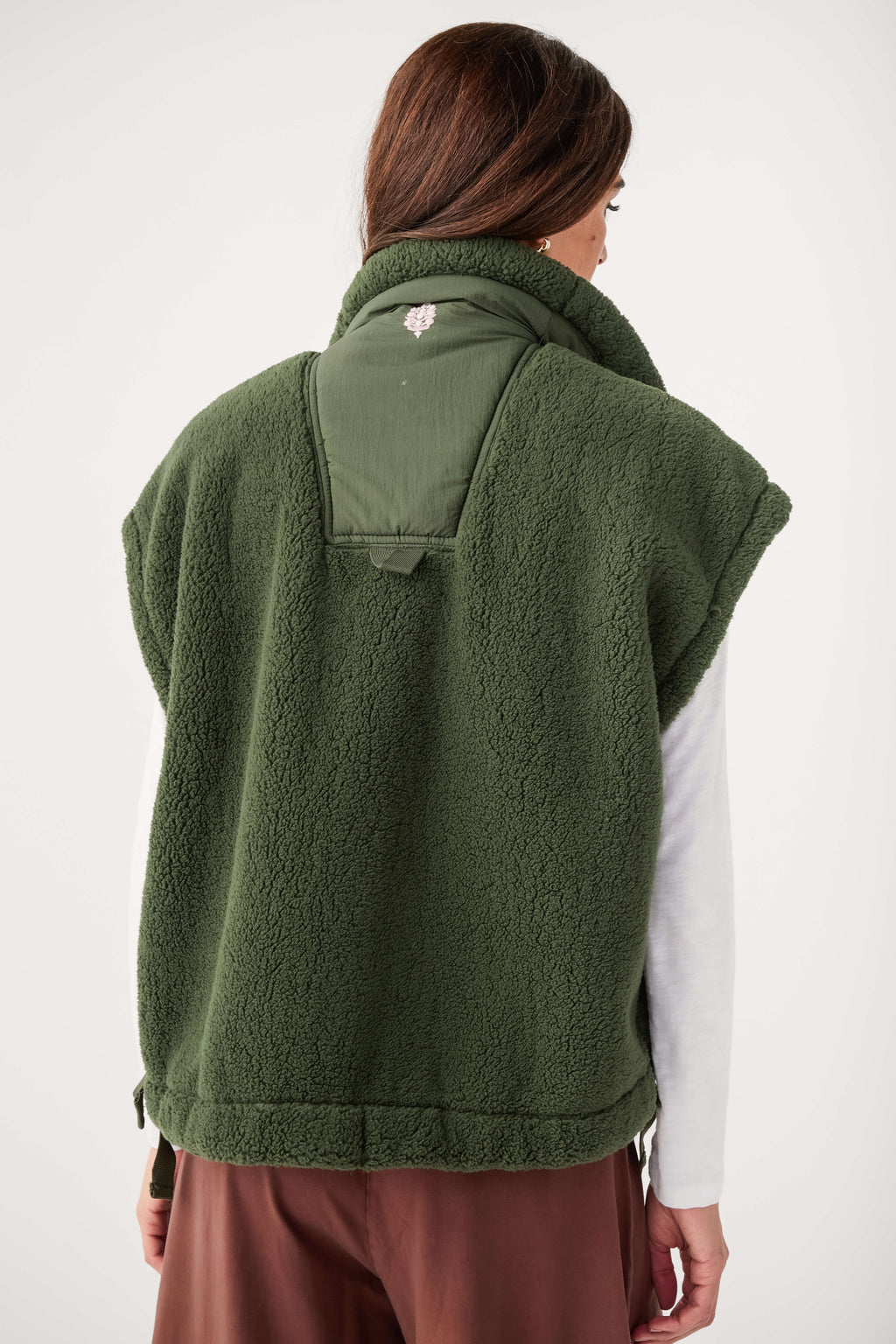 Green fleece vest with high collar and chest pocket opening, back view