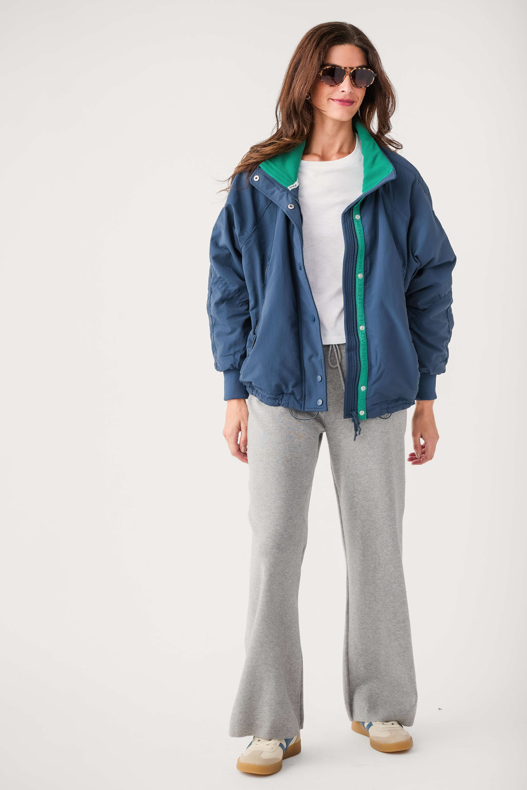 Midnight navy field jacket with green trim, snap front, and drawcord hem