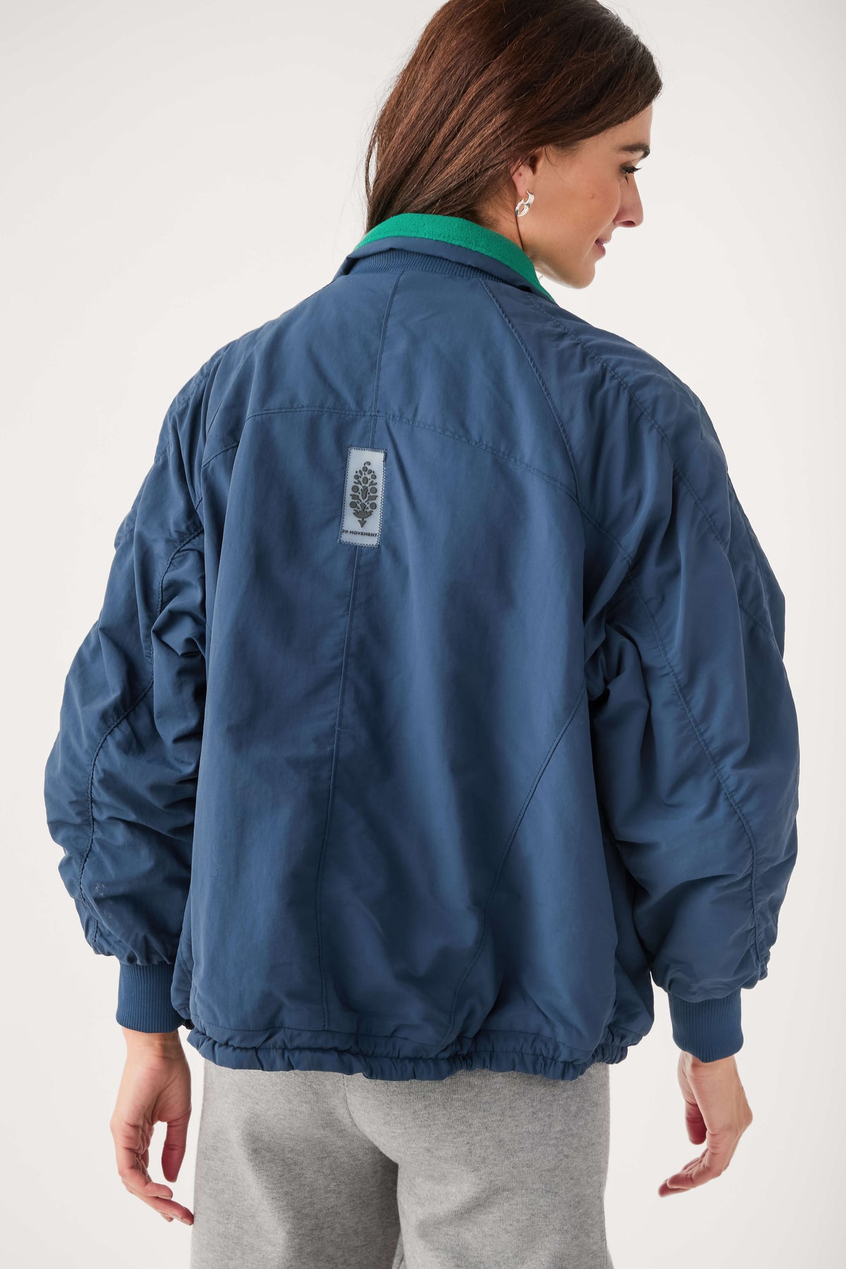 Midnight navy field jacket with green collar and small back logo patch