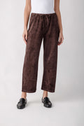 Brown suede pull-on pants with drawstring waist and straight wide-leg silhouette, cropped ankle length.