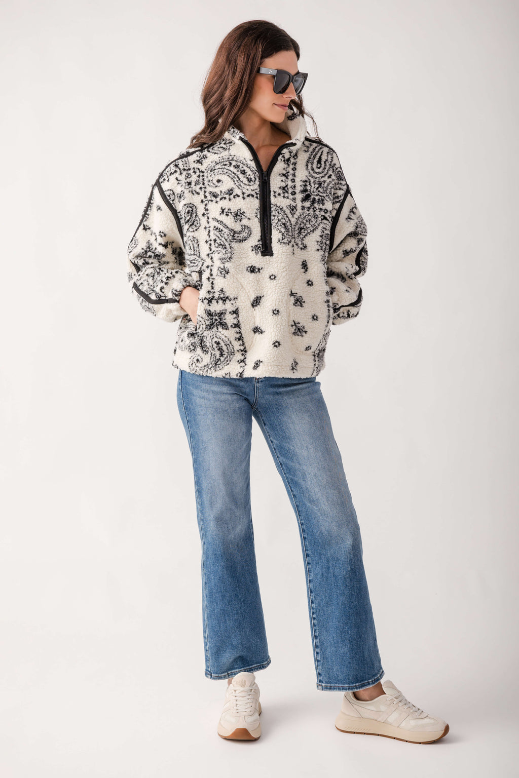 Cream and black Gola Seattle sneakers with retro-style sole, worn with blue jeans.