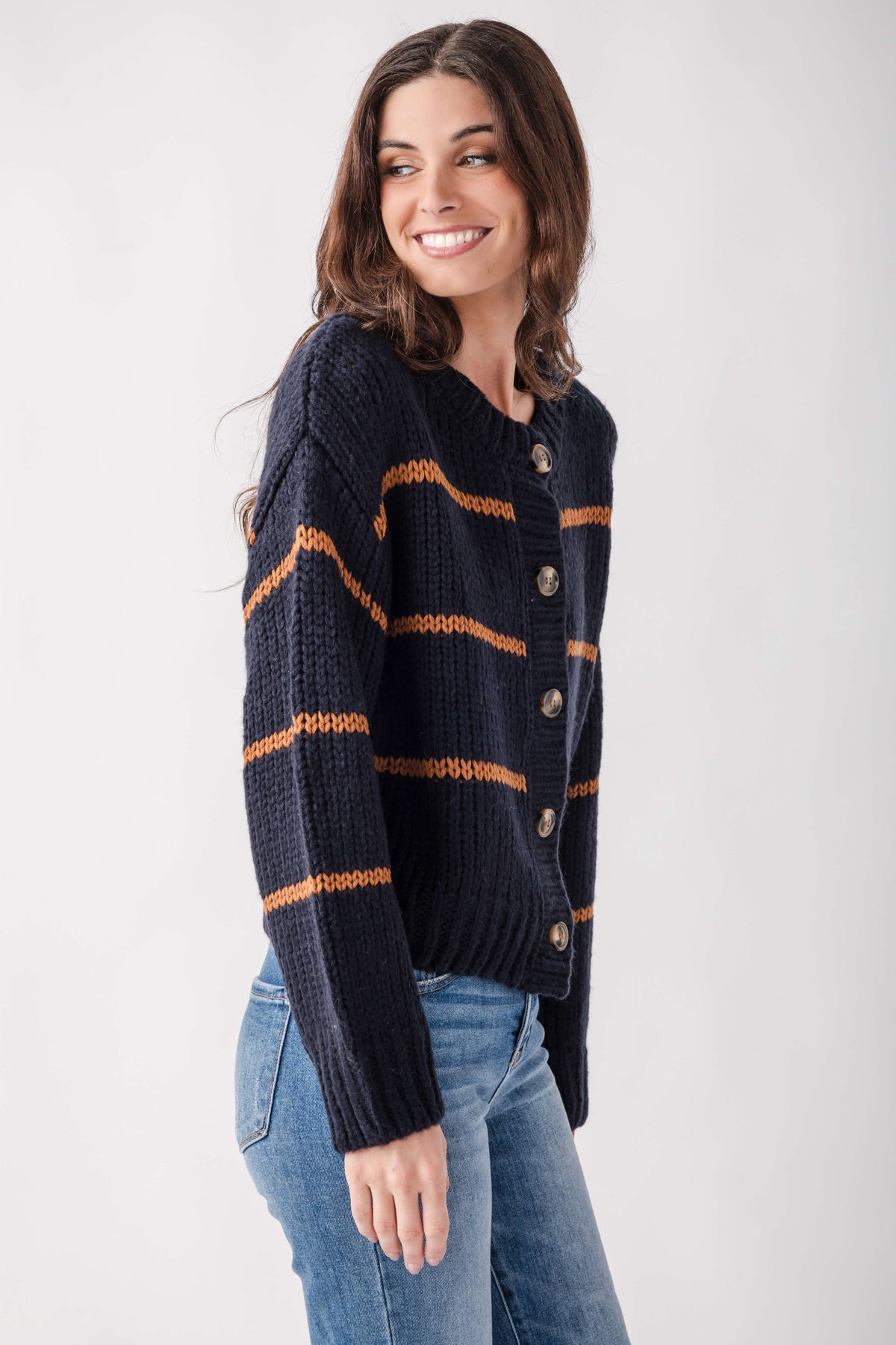 Navy cardigan with orange horizontal stripes, button front closure, and ribbed knit texture.