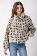 Cream and green checkered sherpa fleece jacket with full zip front and collar on model.