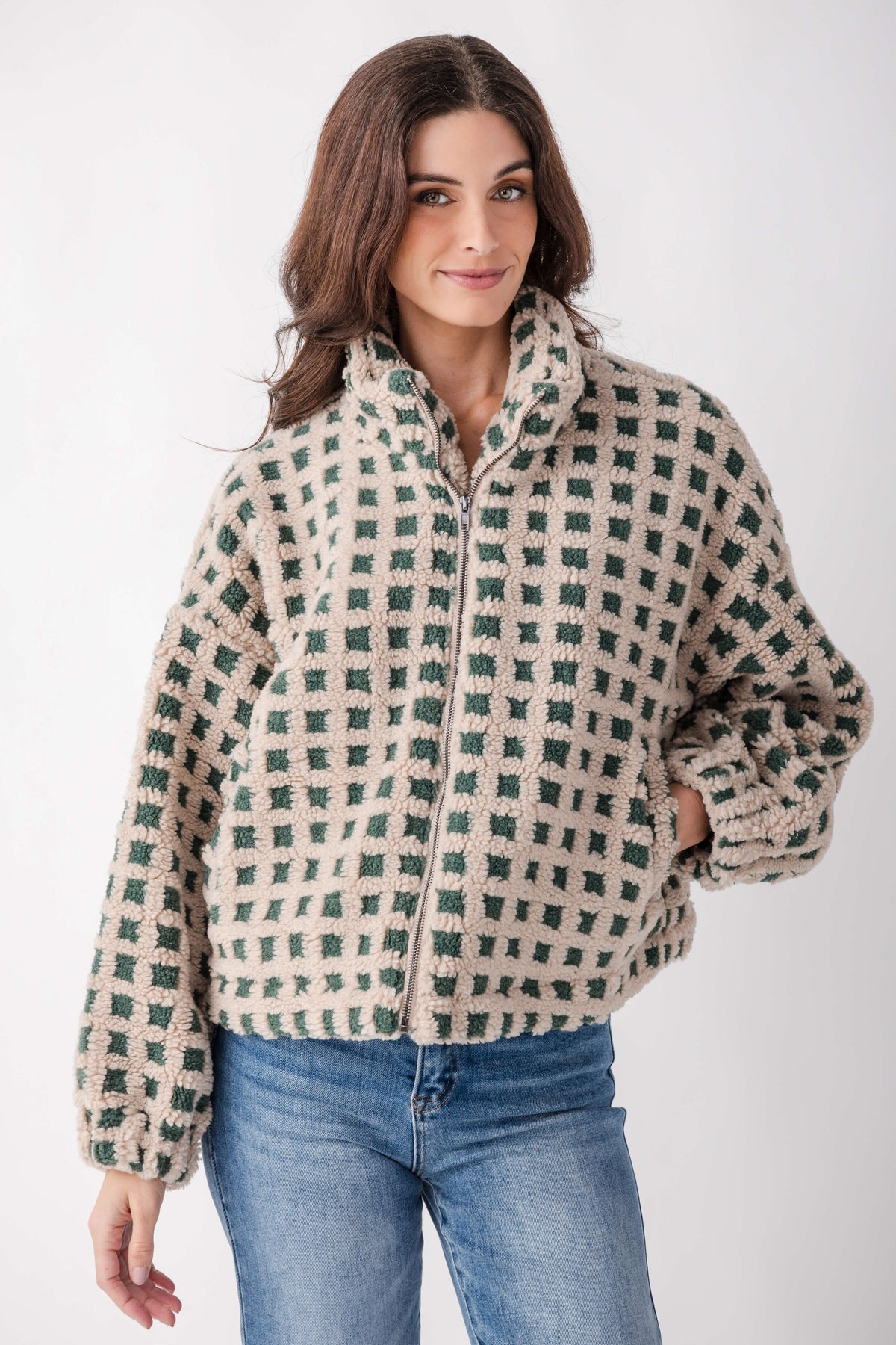 Cream and green checkered sherpa fleece jacket with full zip front and collar on model.
