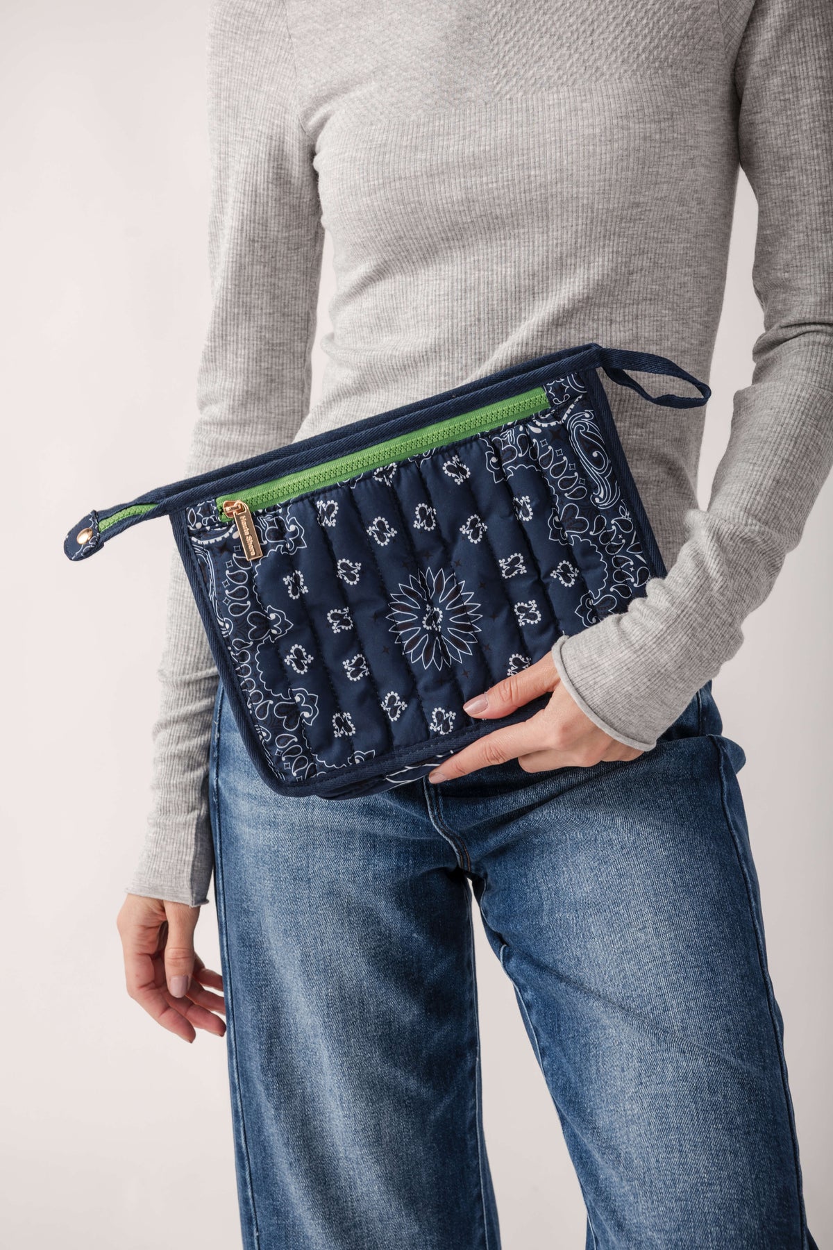 Navy bandana pouch with white floral and paisley print, neon green trim, and wrist strap.