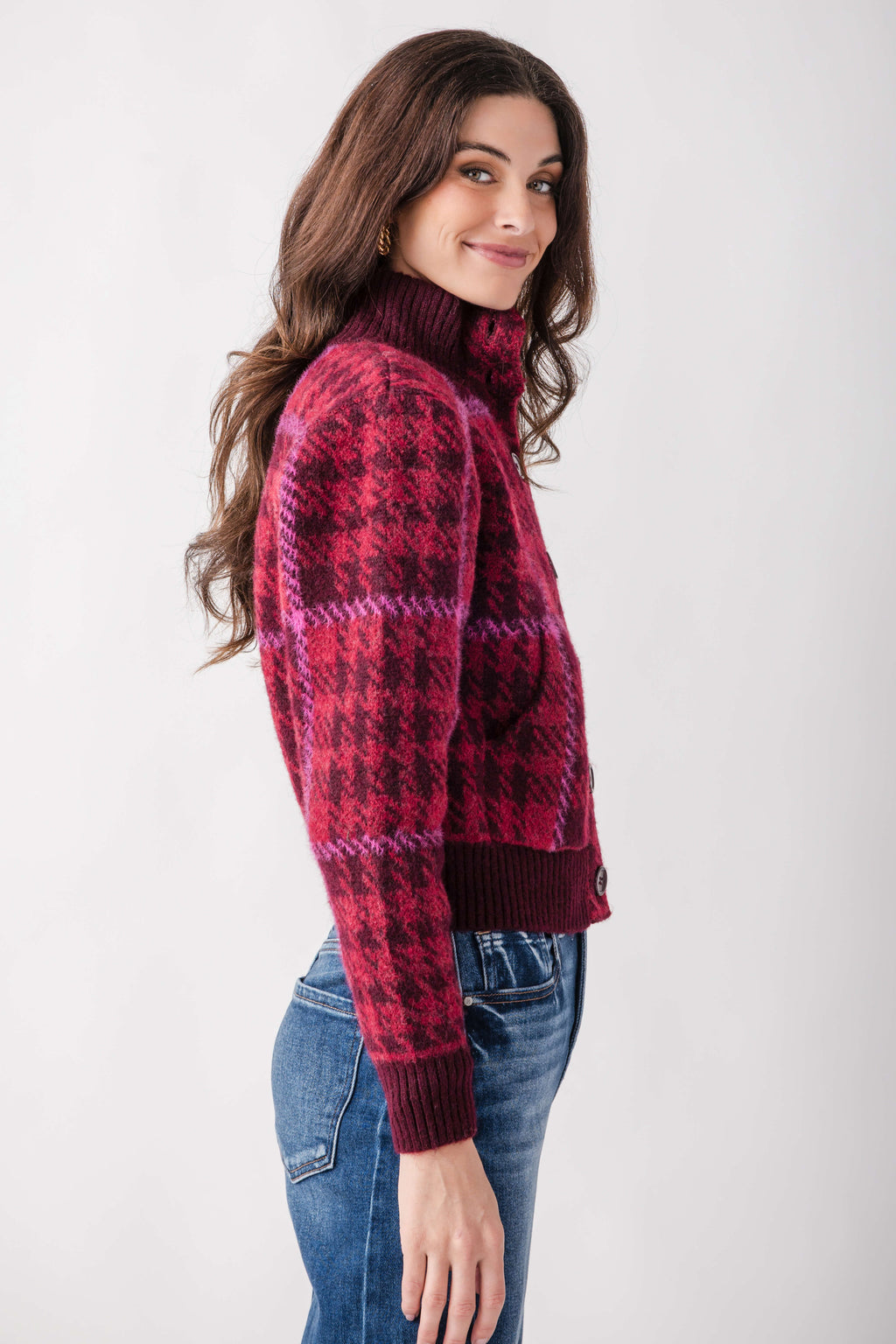Red and burgundy patterned mock neck jacket with ribbed cuffs and hem, worn with blue jeans.