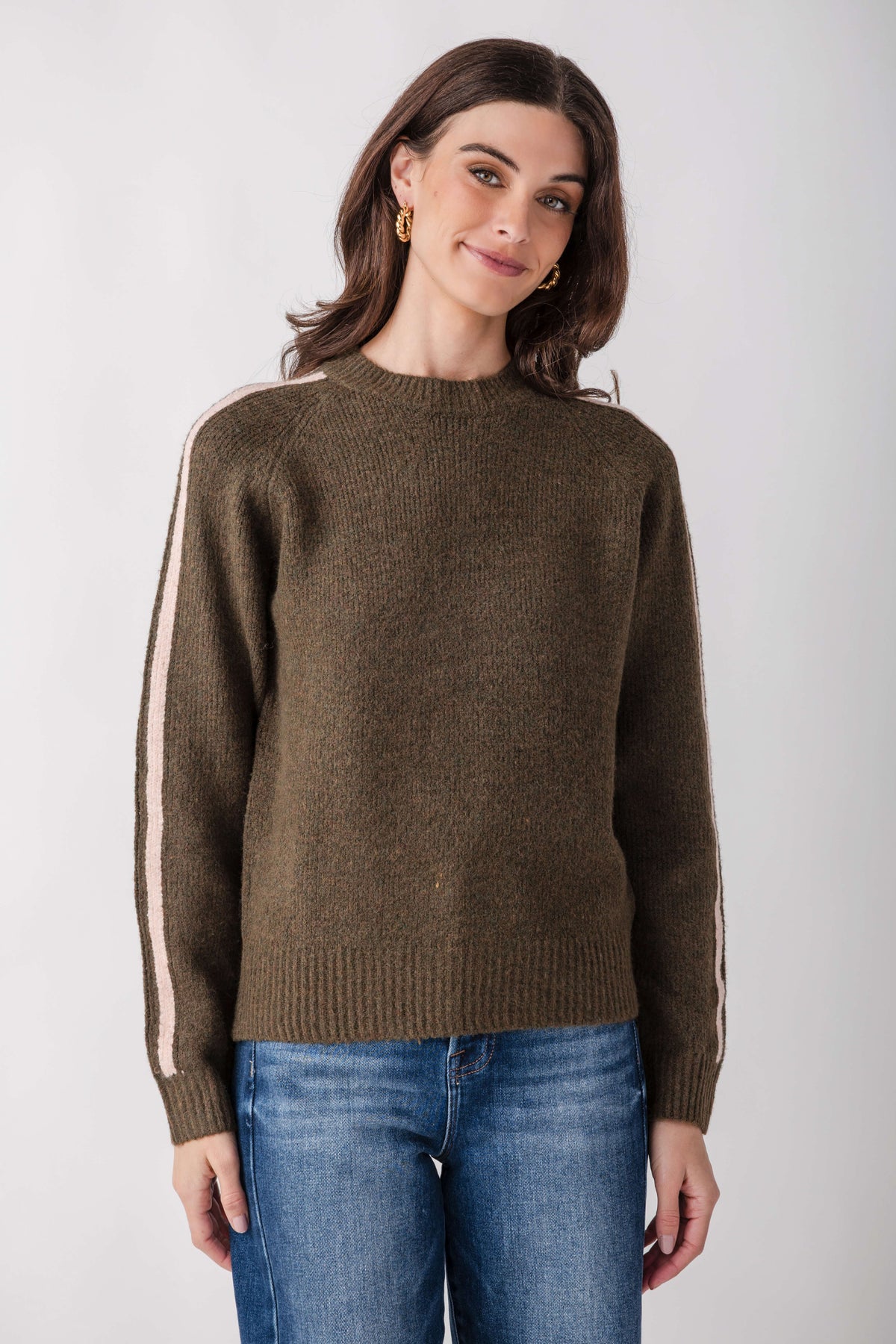 Olive knit sweater with cream contrast stripes down sleeves and crew neckline.